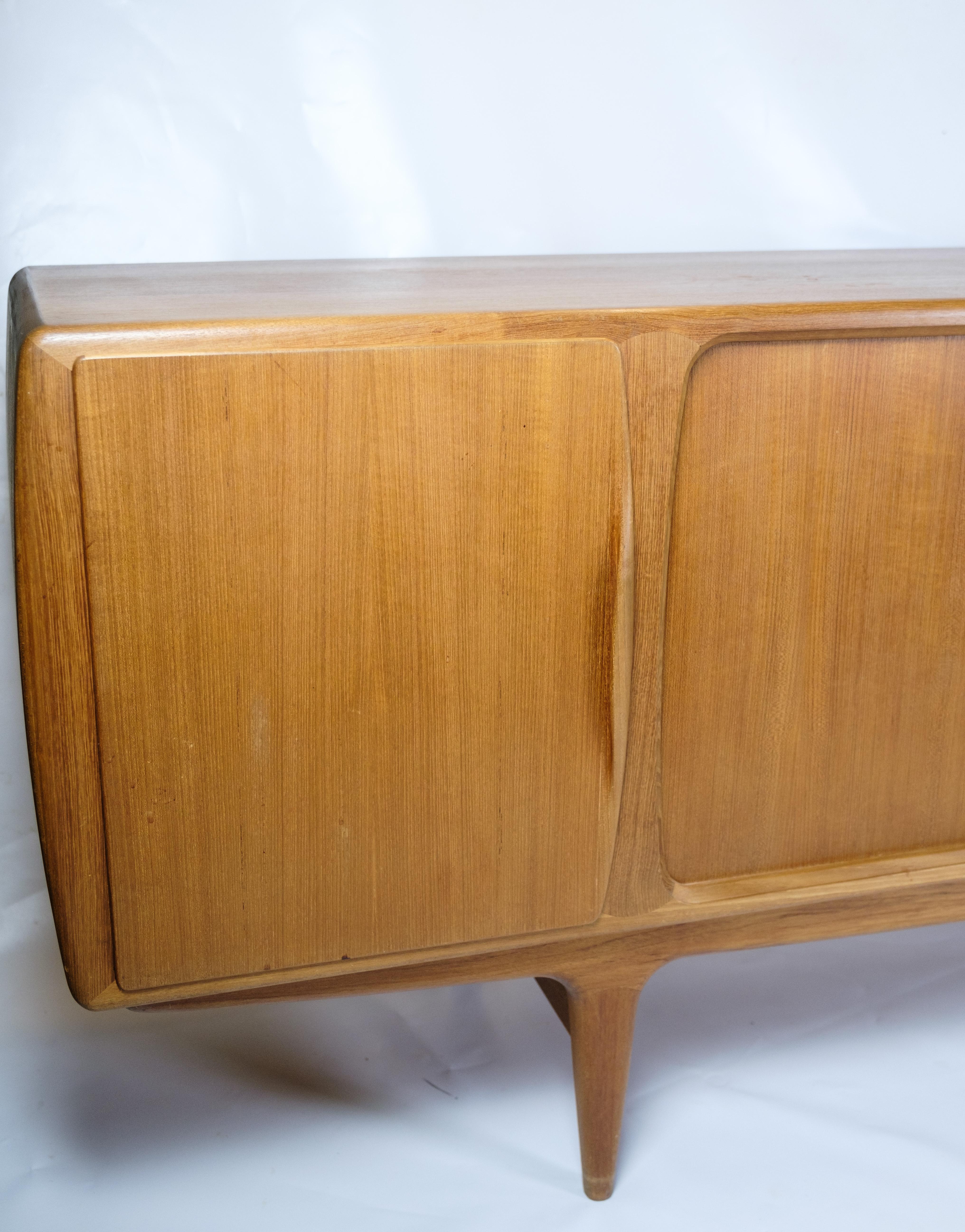 The sideboard with jalousie doors, designed by Johannes Andersen, Model 19 and manufactured by Uldum Møbelfabrik in 1960, represents a beautiful example of mid-20th century Danish furniture art.

Johannes Andersen was known for his talent for