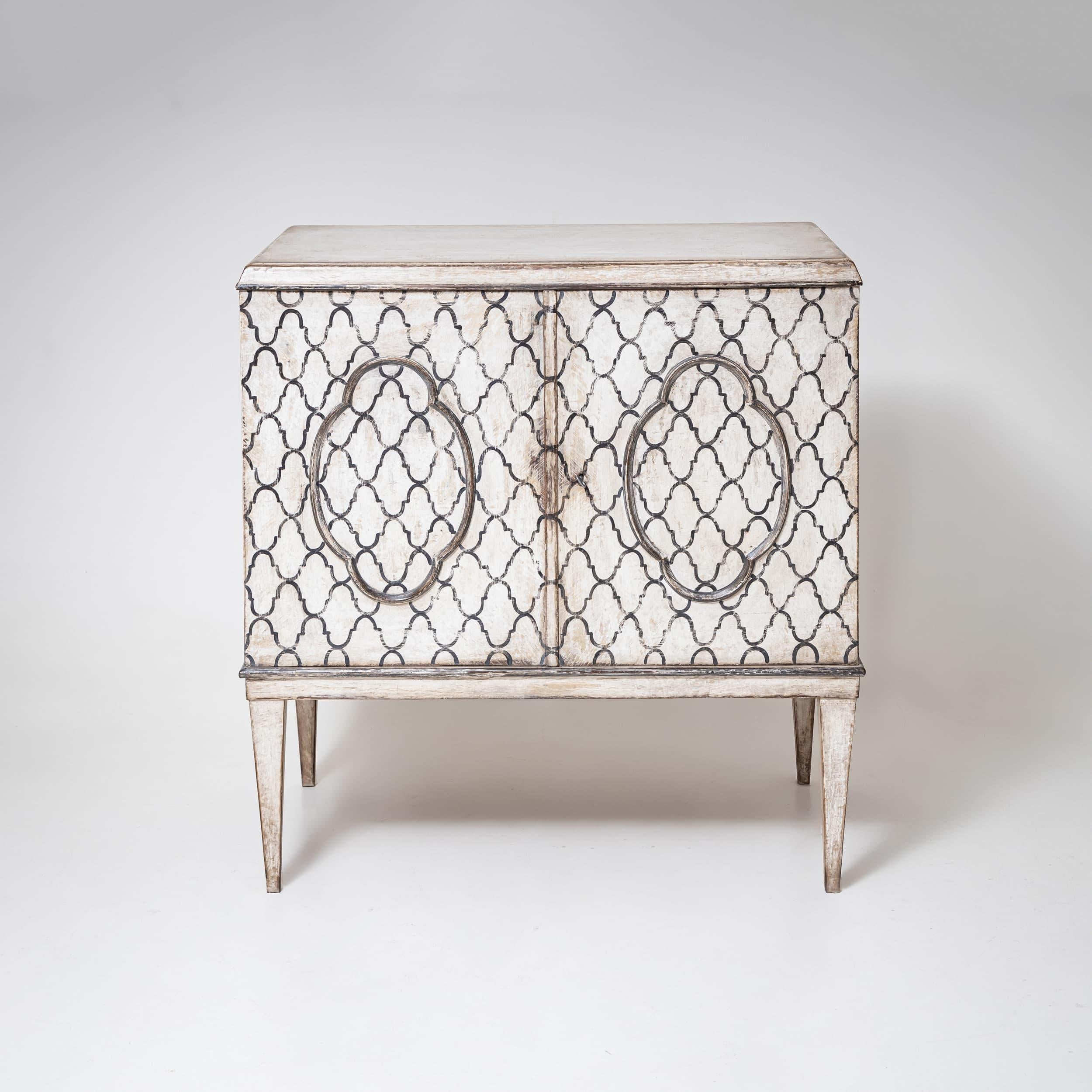 Elegant two-door sideboard from the early 20th century featuring a newly applied, skillfully hand-painted finish. The decorative pattern of dark, flowing lines with oval ornaments contrasts beautifully against the light background, giving the piece