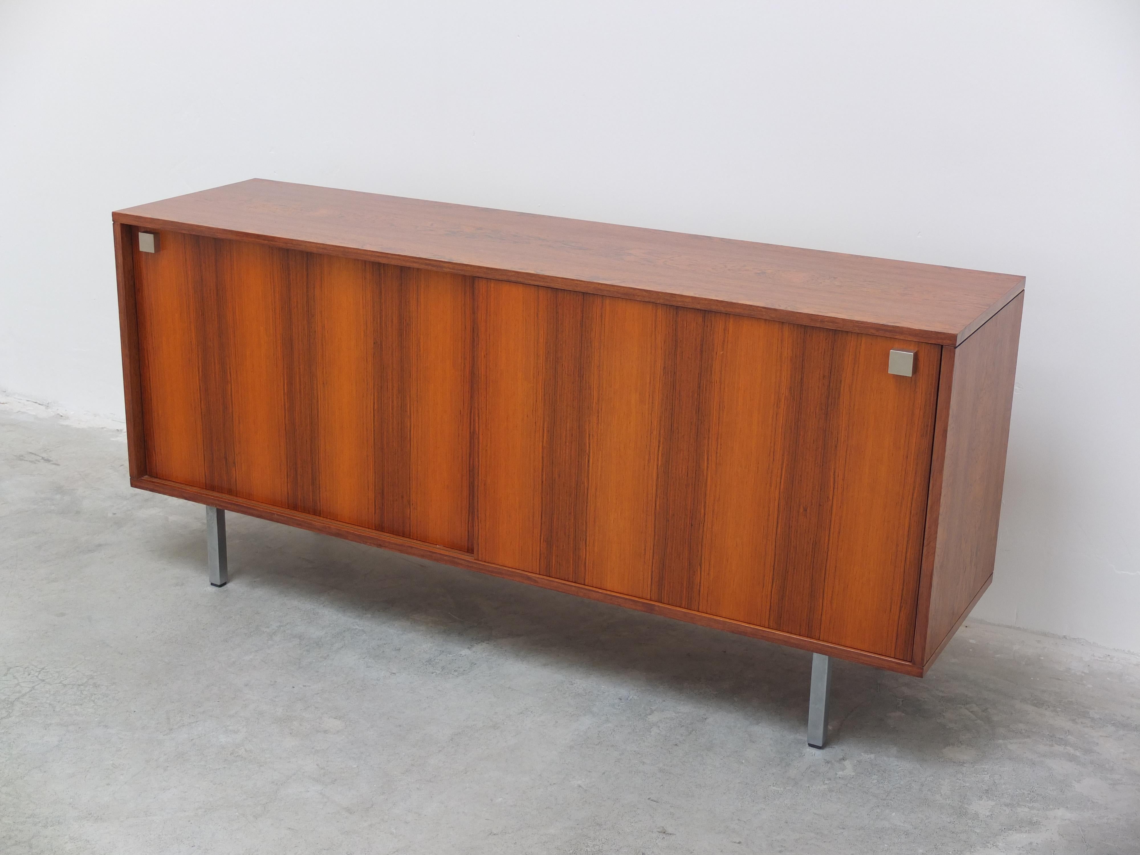 Nice medium sized sideboard designed by Alfred Hendrickx for Belform, 1960s. Made of rosewood with a beautiful woodgrain and metal feet. This model features two sliding doors with two rosewood drawers on the right side. Notable here is the compact