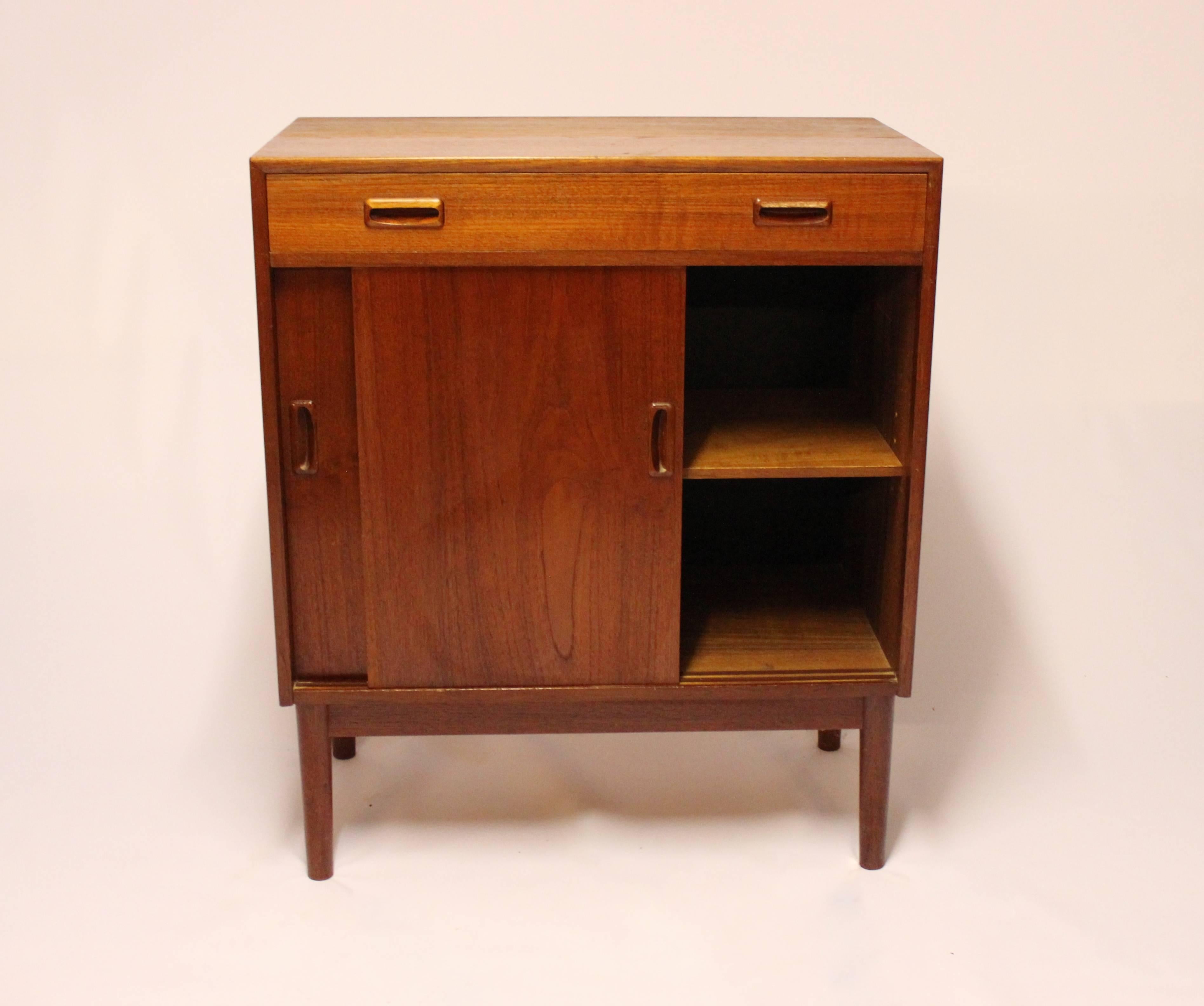 Sideboard with sliding doors in teak of Danish design from the 1960s. The sideboard is in great vintage condition and we have one more in stock.