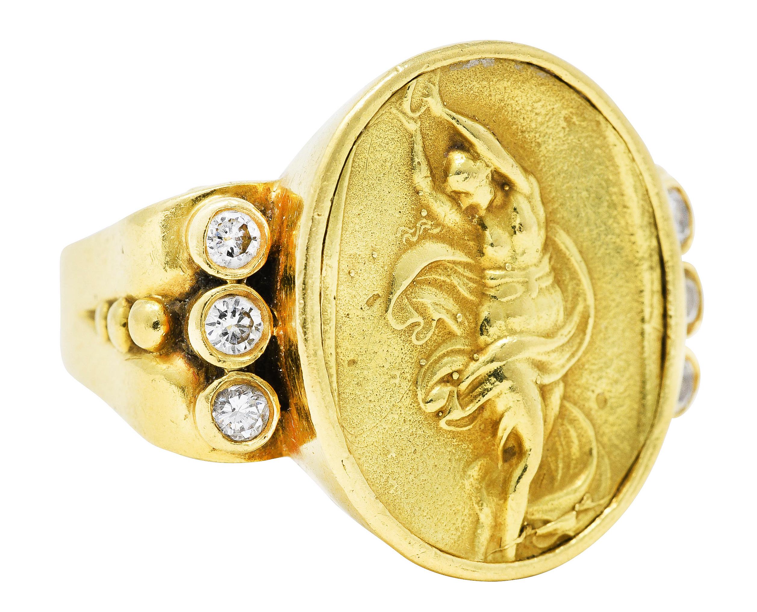 Substantial signet style ring features an oval cartouche depicting a dancing muse with tambourine

With highly rendered swirling garments - Erato is the muse of lyric and love poetry

Flanked by bezel set round brilliant cut diamonds

Weighing in