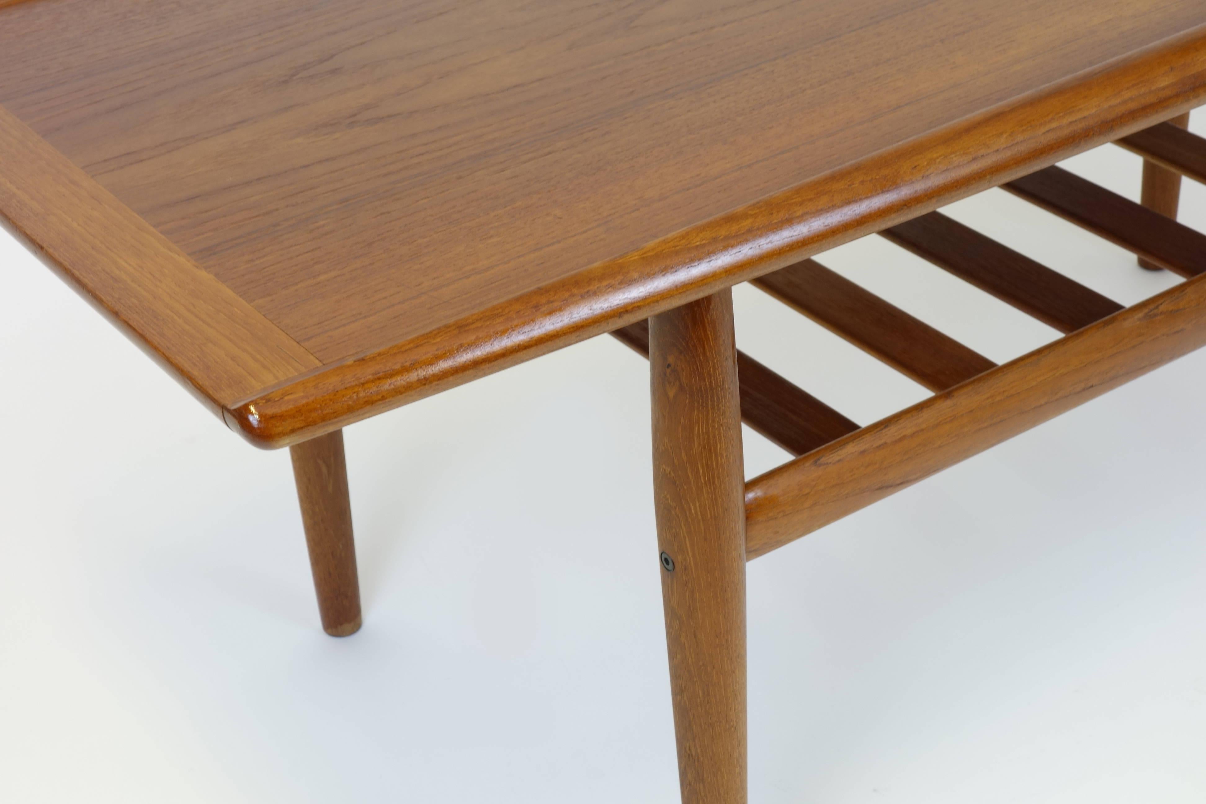 Sidetable original coffeetable by Grete Jalk for Dansk Mobler, Denmark, 1960ies. Completely solid teakwood frame and top. Very refined detailing at the table top with inside curved edges. Inside the table legs lies the rectangular brass inlay as a
