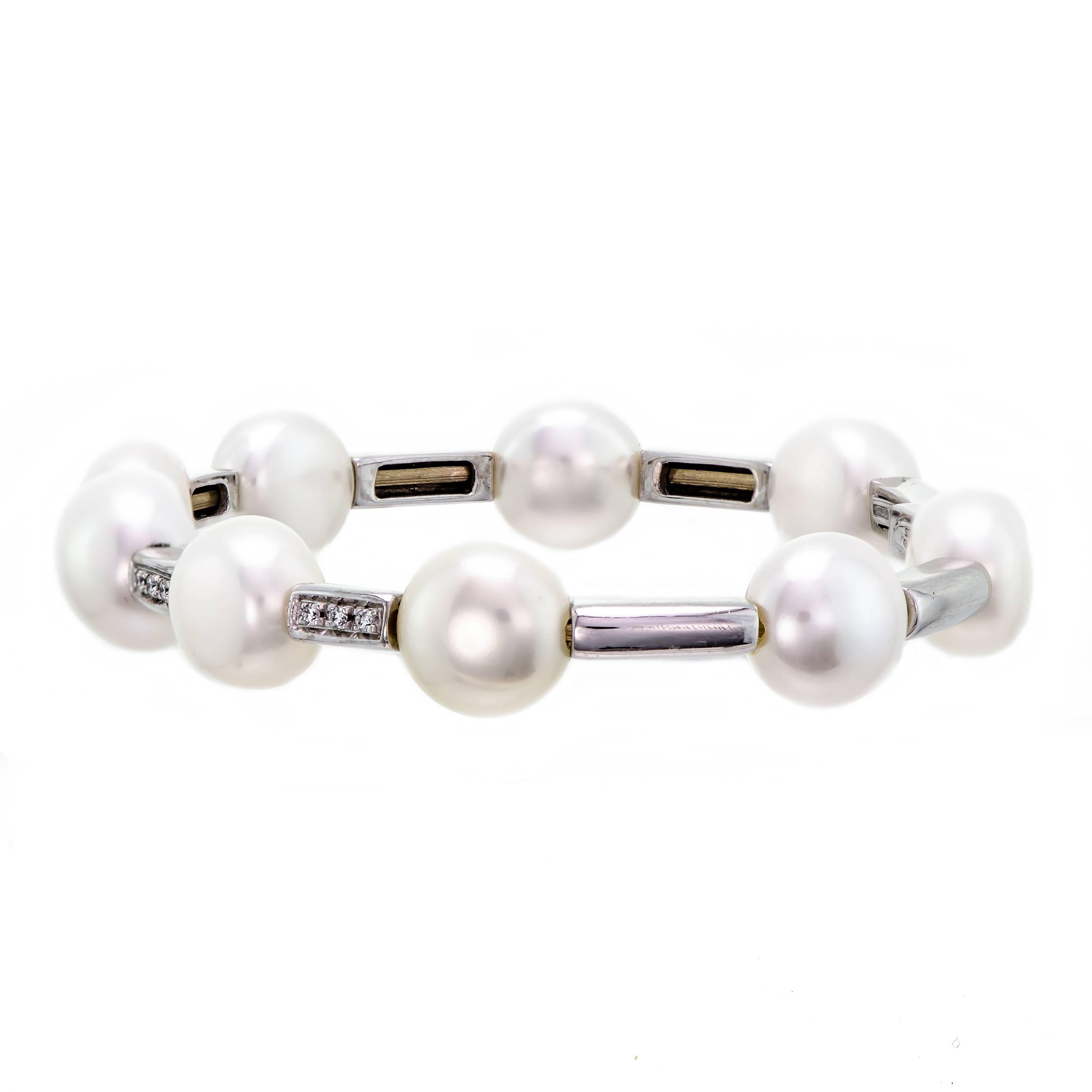 A Classic Design by Sidney Garber this freshwater pearl, and diamond flexible cuff bracelet is crafted in 18 karat white gold. Alternate links of polished white gold sit between freshwater pearls allowing the bracelet to move with ease. Four (4) of