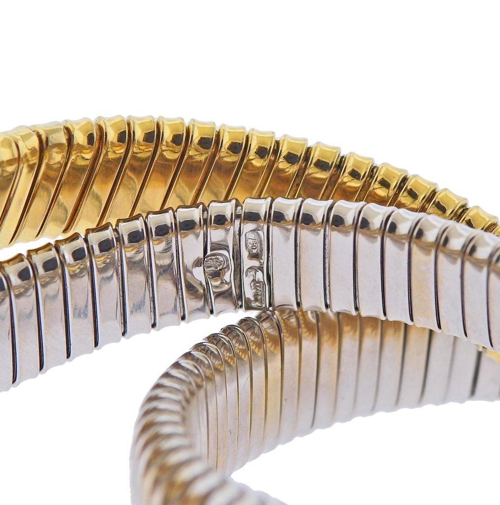 18k gold rolling bangle bracelet by Sidney Garber, featuring two white and one yellow gold bracelet. Retail $16500. Bracelet will fit approx. 7-7.5