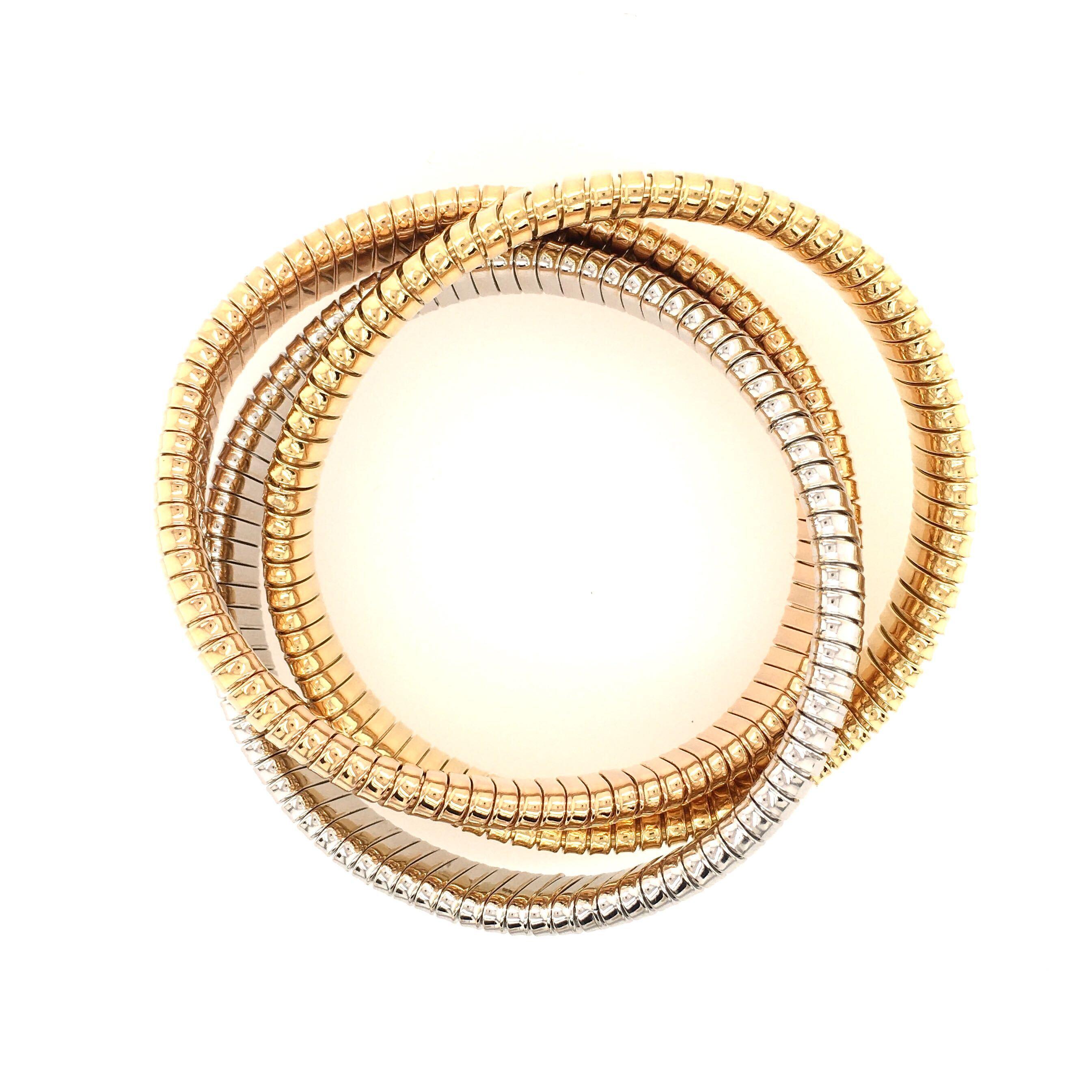 An 18 karat rose, yellow and white gold rolling bracelet. Sidney Garber. Deigned as slightly flexible intertwining rose, yellow and white gold gas pipe bangles, Width of each bracelet is approximately 1/2 inch, inside measurement is approximately 7