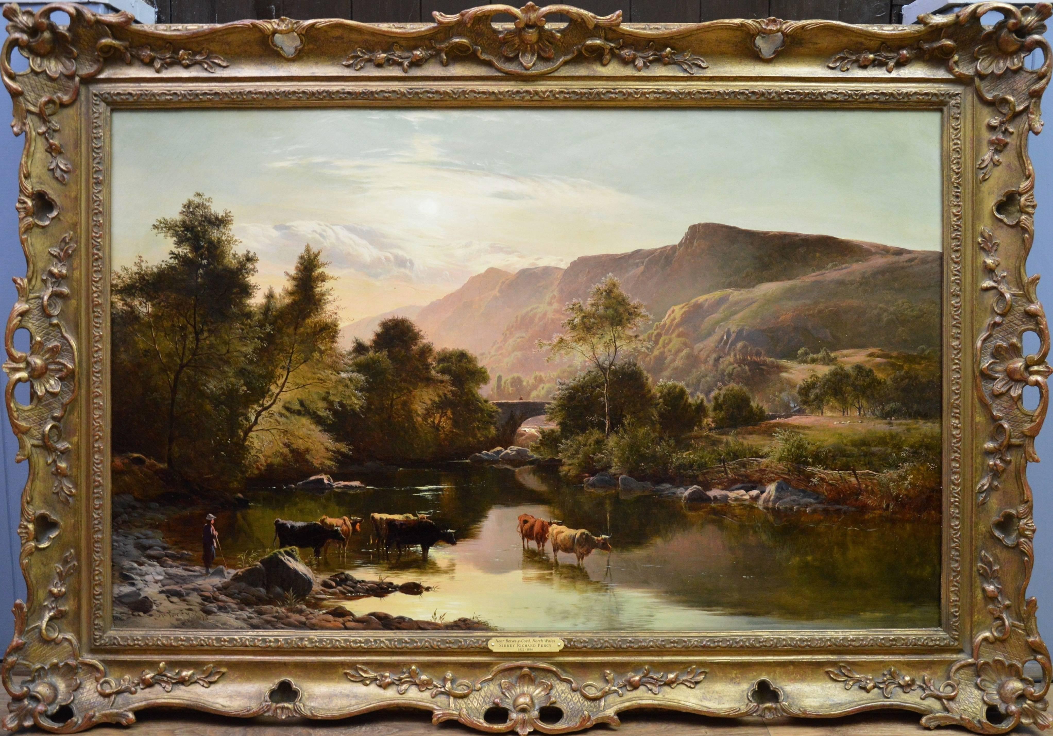 This is a very fine large 19th century oil on canvas depicting cattle watering at the riverside in an extensive mountainous summer landscape ‘Near Betwys-y-Coed, North Wales’ by the important Victorian landscape painter Sidney Richard Percy