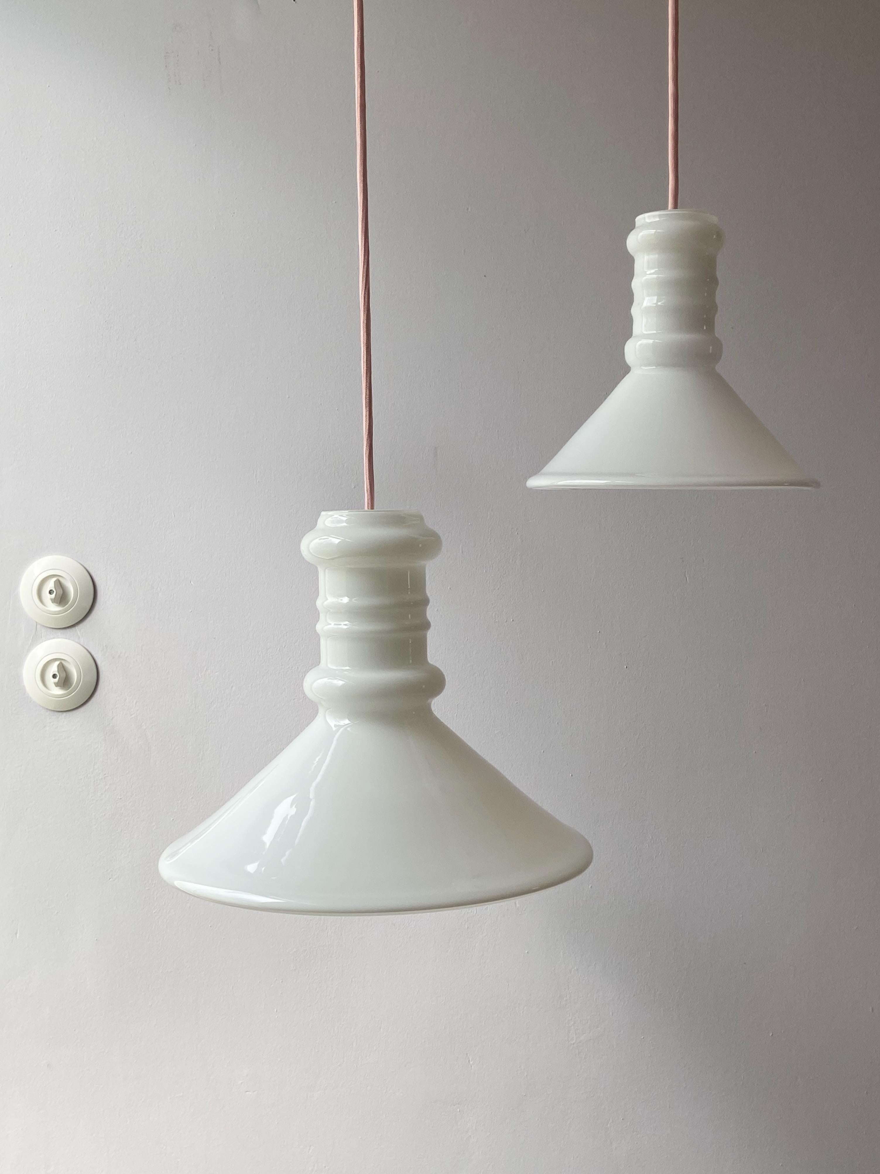 Large Apotheker pendant lamp designed by Sidse Werner for Holmegaard in the 1981. This Danish lamp is made of opaline glass and is whitek with transparent. The lamp is in very good condition, no damages and comes with pink fabric cord.