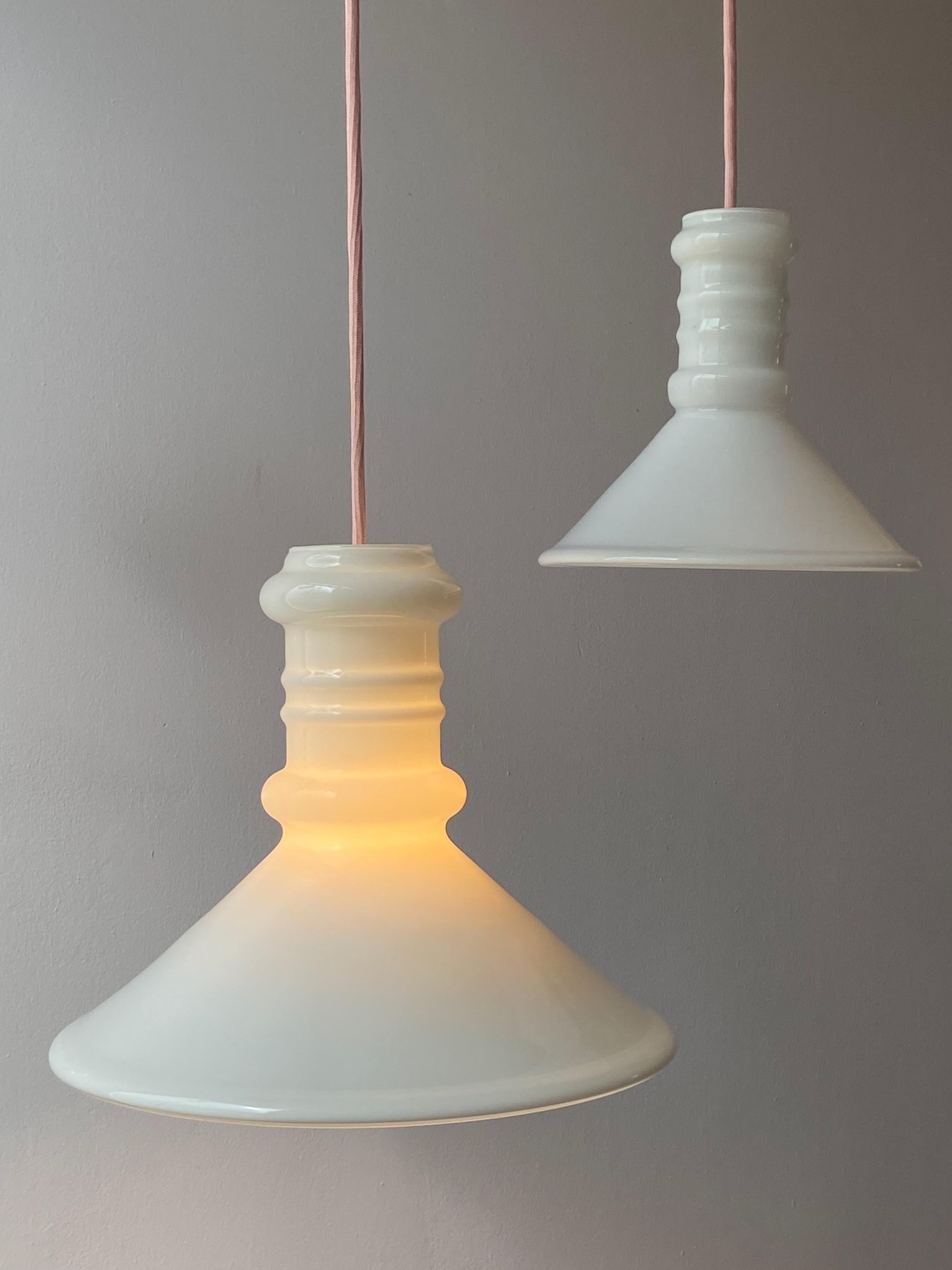 Small Apotheker pendant lamp designed by Sidse Werner for Holmegaard in the 1981. This Danish lamp is made of opaline glass and is whitek with transparent. The lamp is in very good condition, no damages and comes with pink fabric cord.