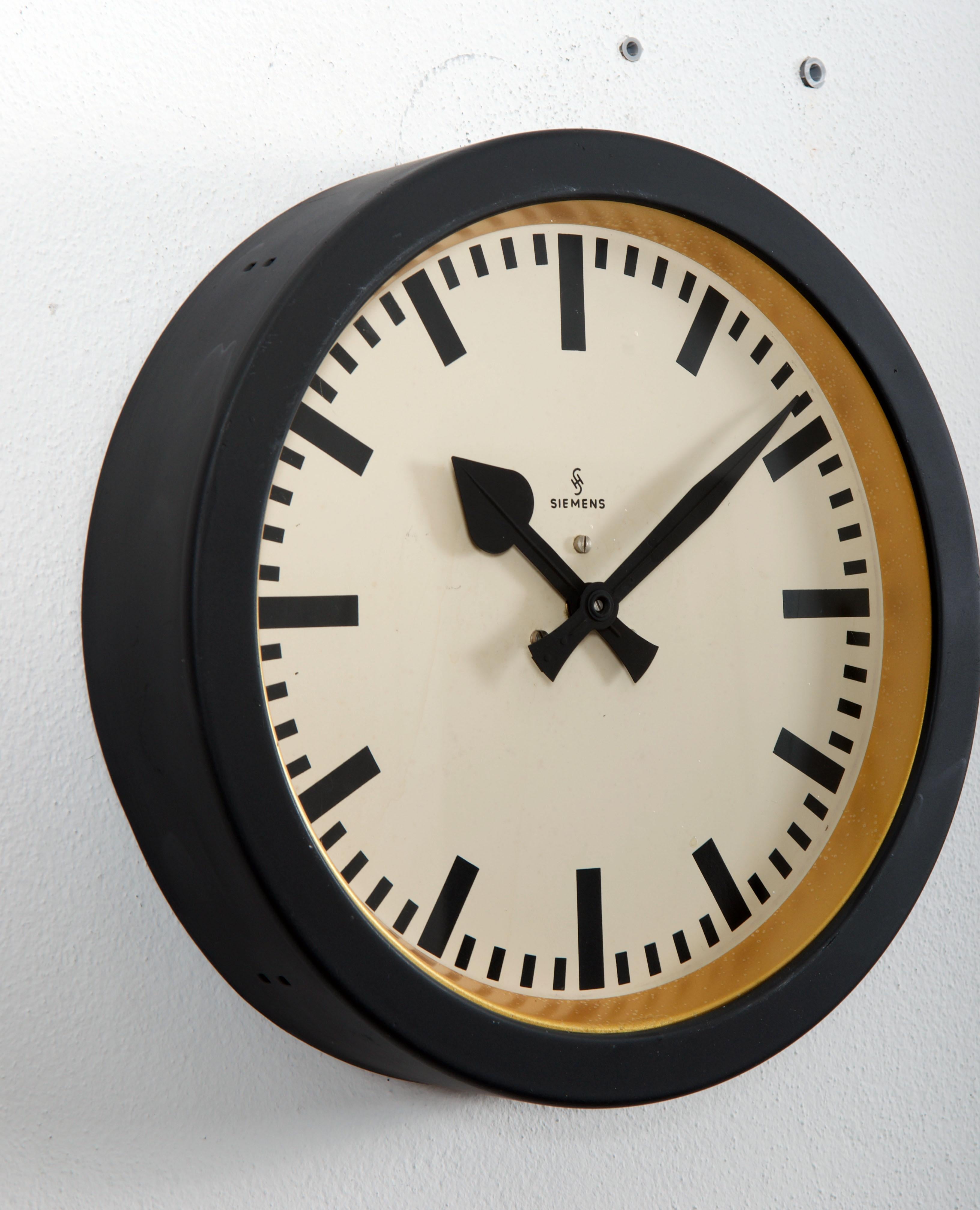 Steel painted with glass front made in Germany in the 1950s.
Formerly a slave clock, it is now fitted with a modern quartz movement with a battery.