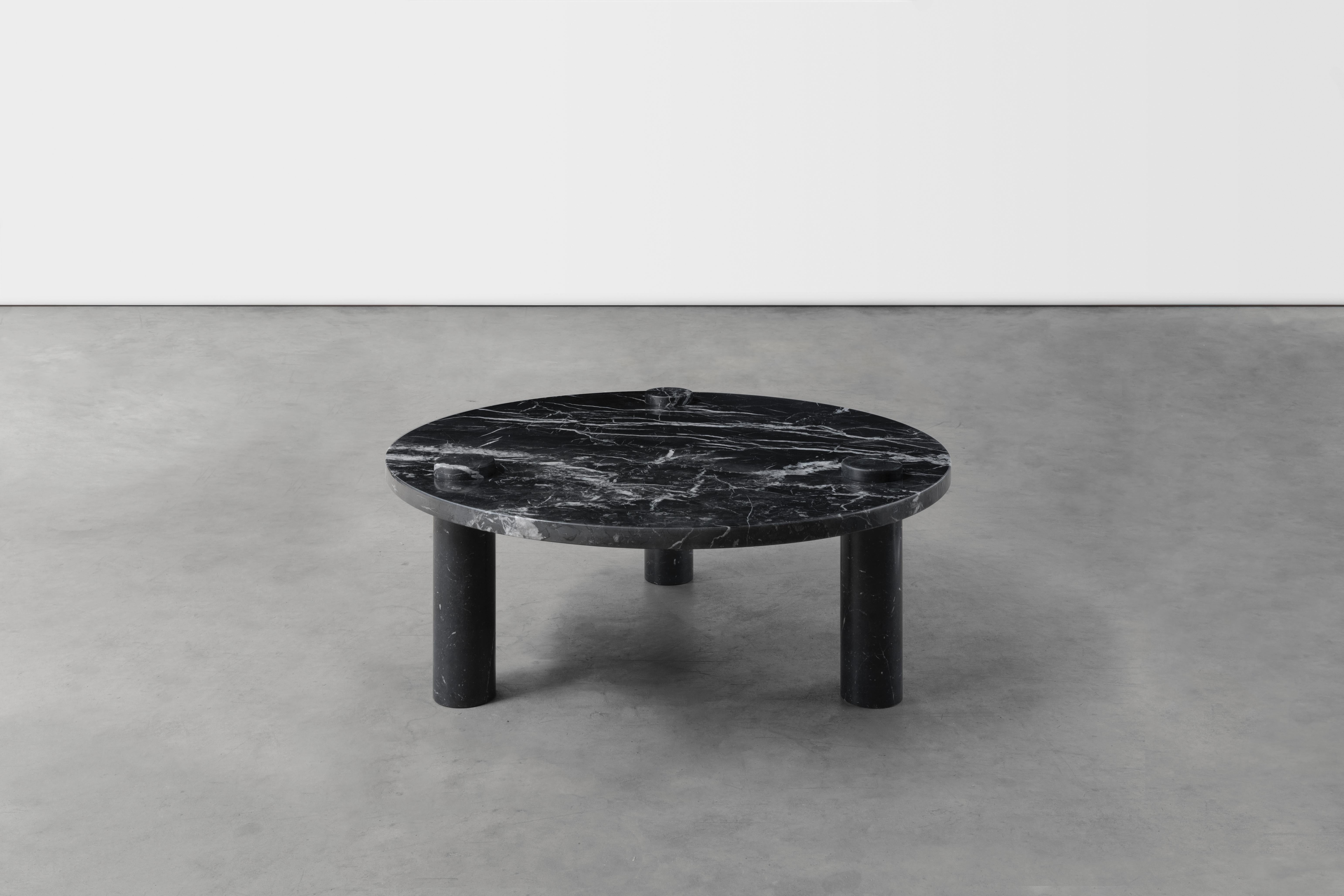 Sienna marble coffee table by Agglomerati
Dimensions: D 90 x H 33 cm
Materials: Nero Maquina marble
Available in other stones.

Sienna coffee table has a minimal architectural form. The circular top appears weightless upon cylindrical legs that