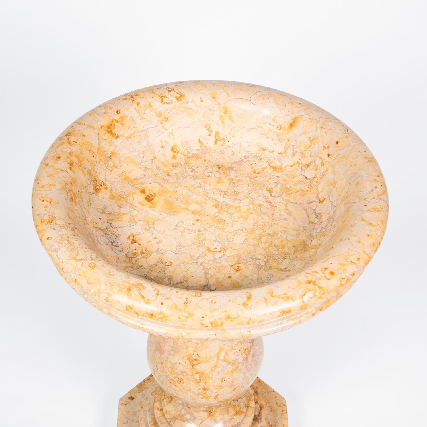 A mid-19th century Italian font with Baluster stem on a hexagonal base, in Sienna marble, circa 1860

In three parts.