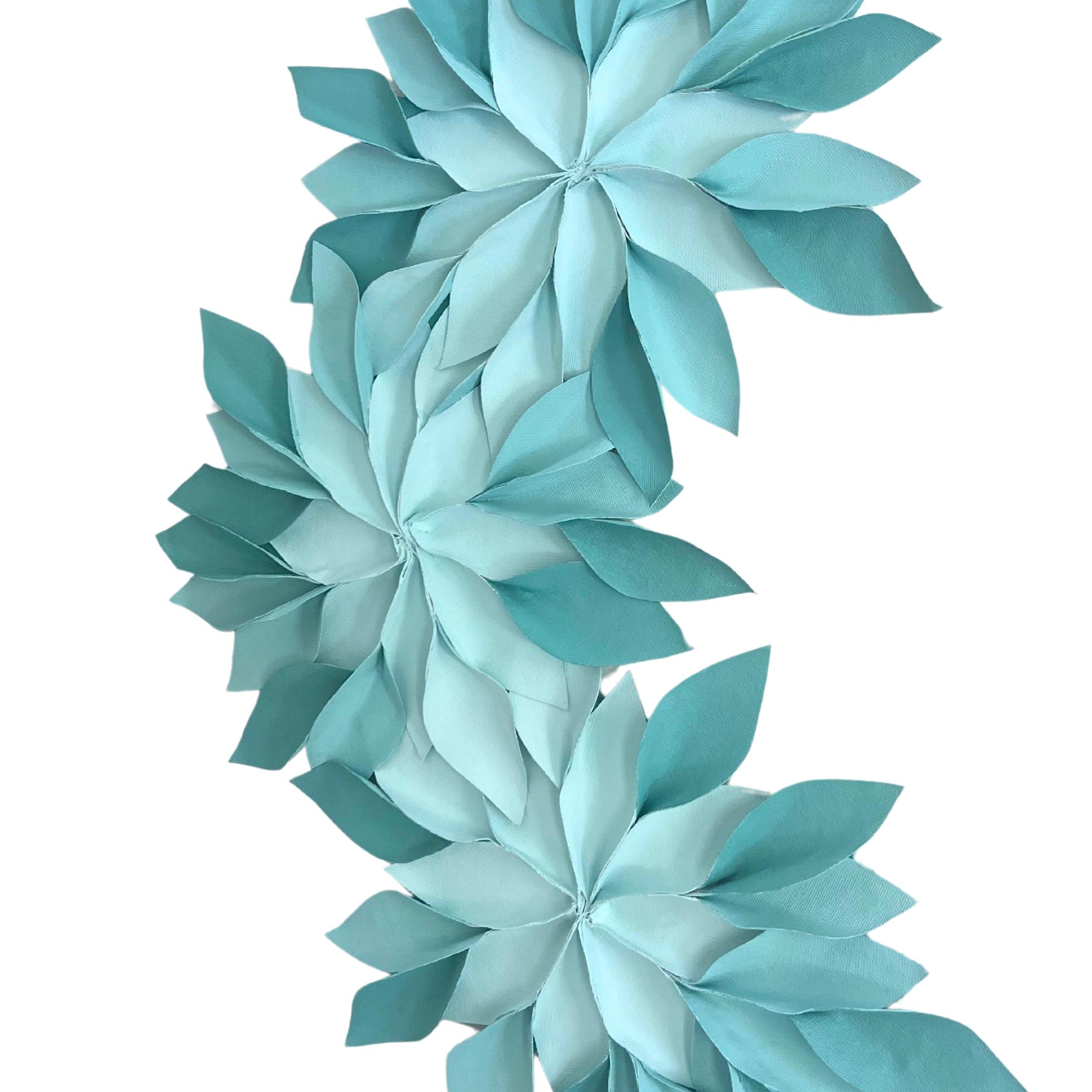 Infused with a tranquil palette, this textile sculpture was crafted to evoke serenity and growth, drawing inspiration from the resilience of nature. Its cerulean hues and wood foundation marry the organic with the tactile, creating a ready-made wall