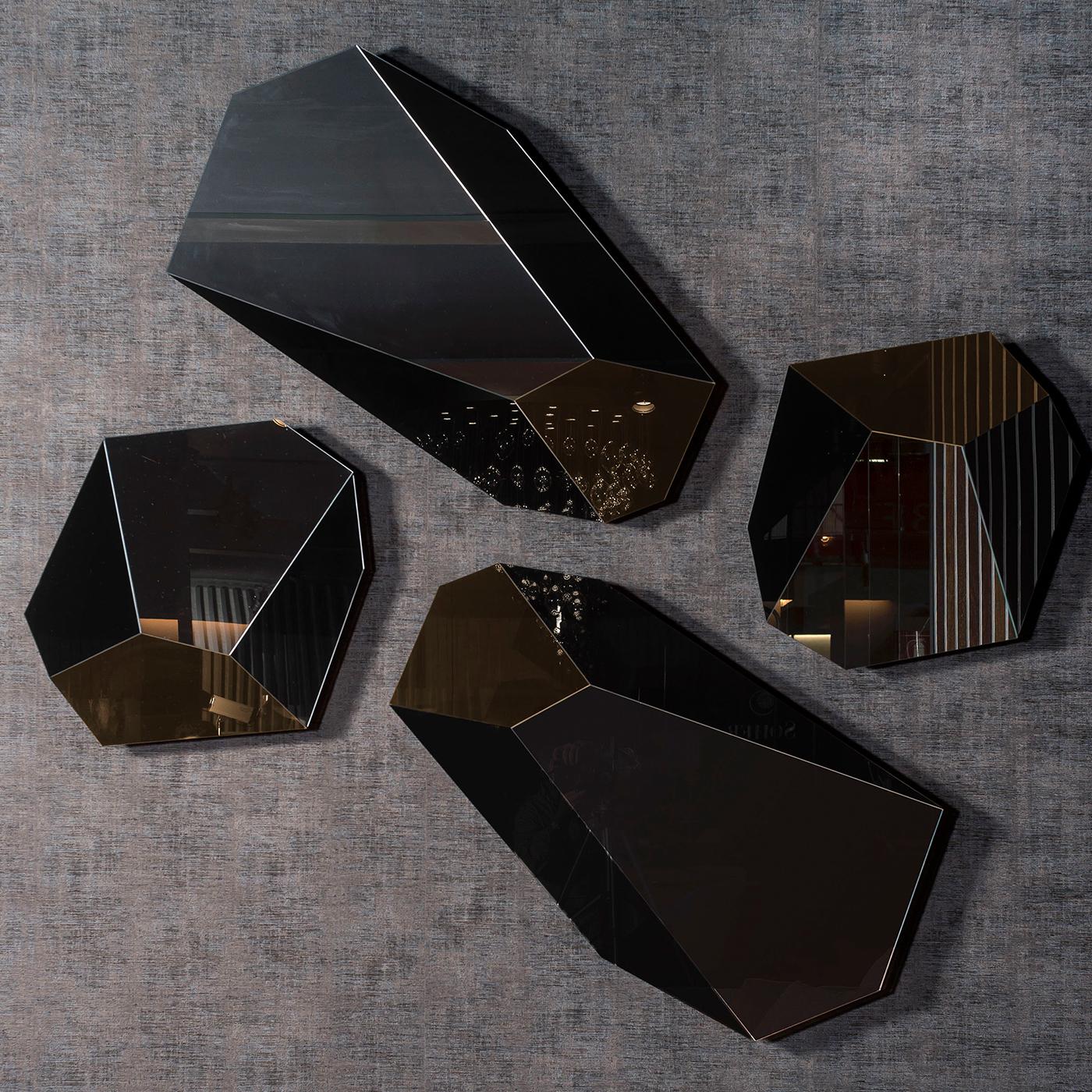 A bold and iconic accent for a contemporary living room, this extraordinary wall mirror boasts a singular interplay of geometric shapes and finishes that makes it distinctive and alluring. Ideally paired with others from the same series, it features