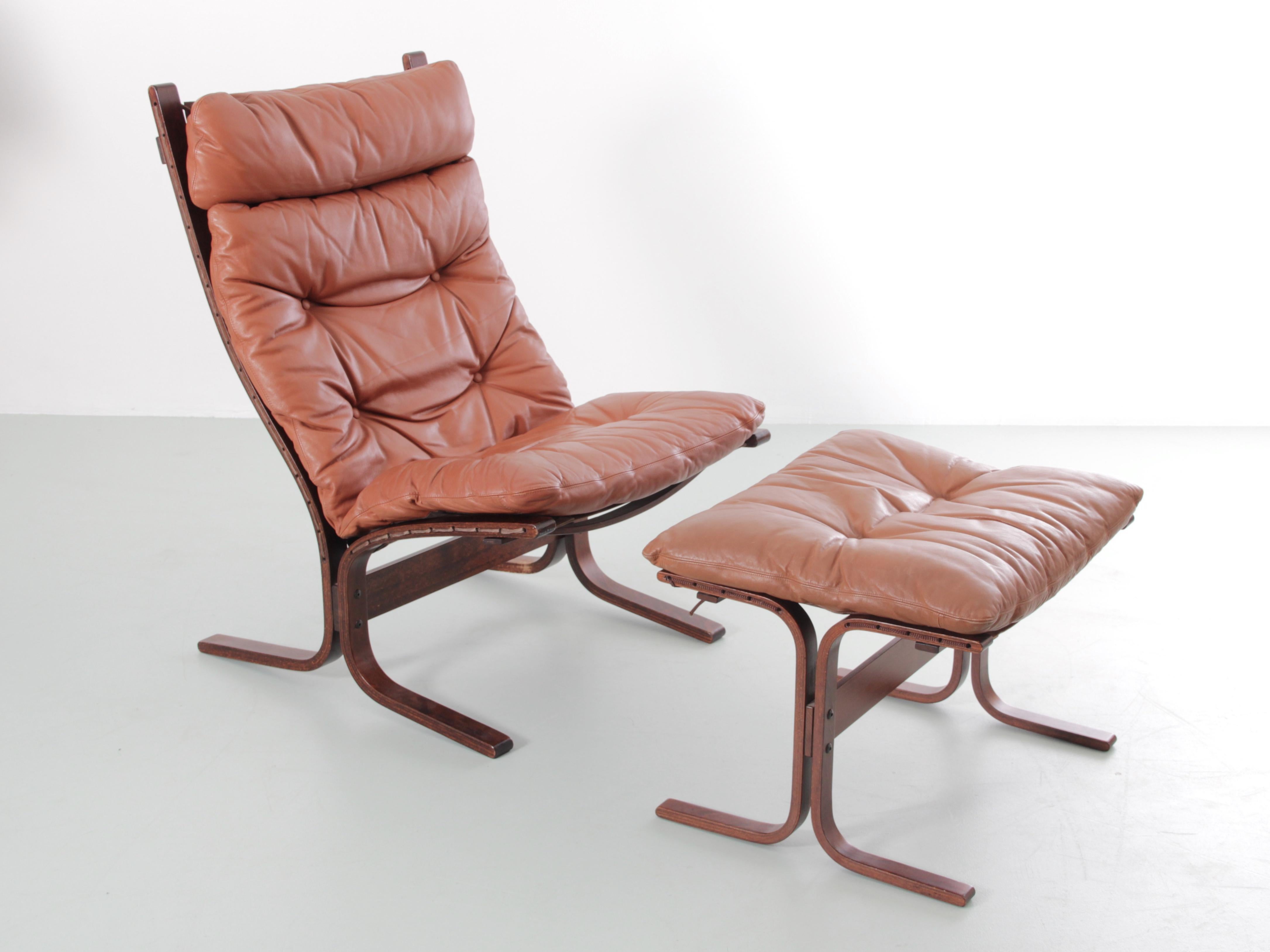 Siesta chair high back and ottoman by Ingmar Relling. Cognac leather. Excellent original condition.
