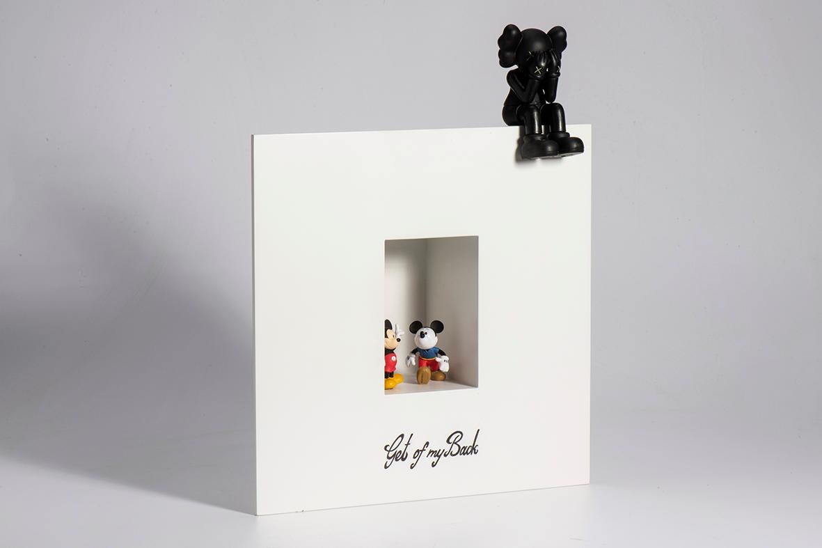 A unique artwork crafted from Plexiglas, featuring an engraved phrase that adds depth and meaning. Perched atop the artwork’s frame is a small figurine, creating a playful yet thought-provoking contrast between words and form. For wall installation
