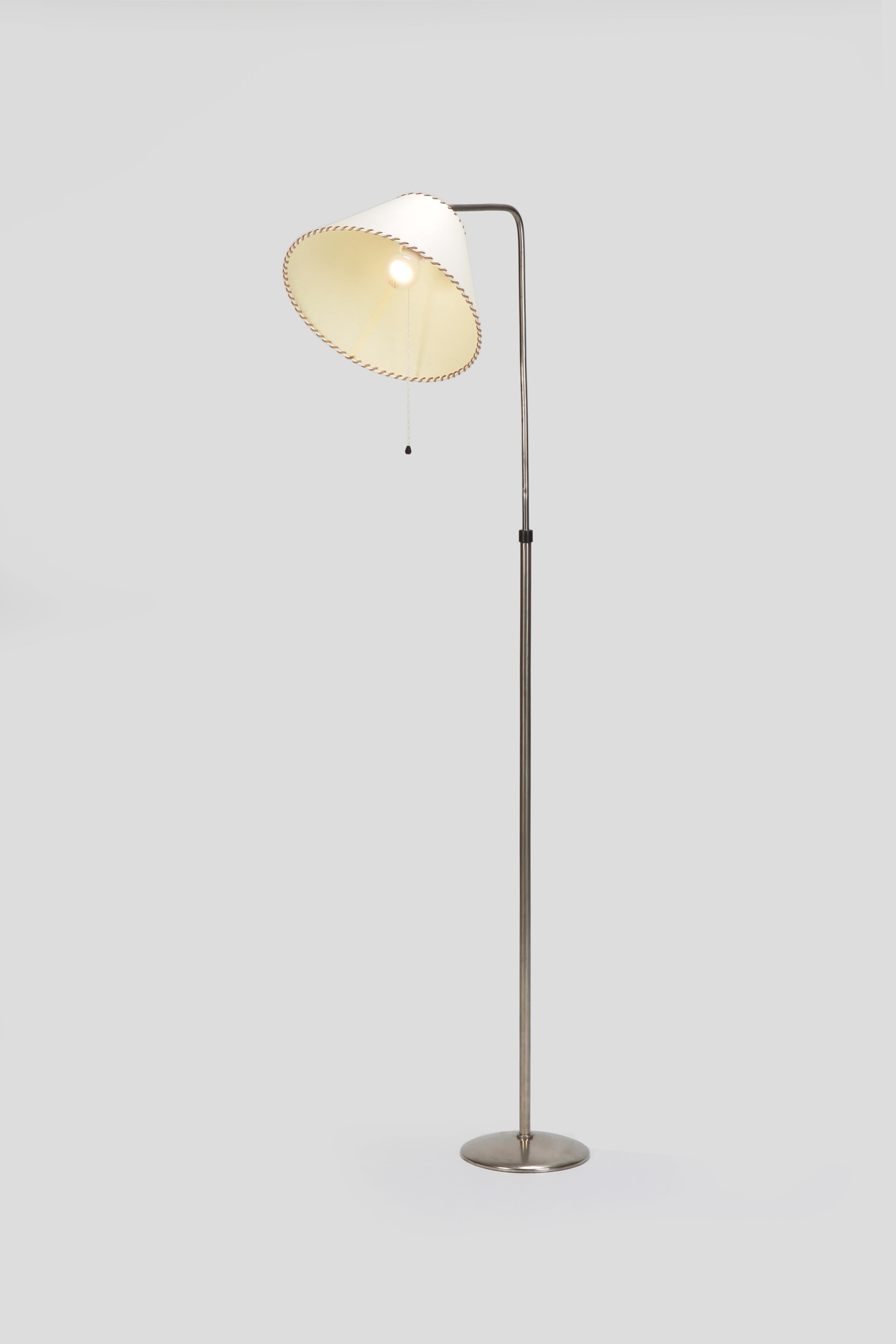 Sigfried Giedion floor lamp manufactured by BAG Turgi in the 1940s in Switzerland. Won the price “die Gute Form” in 1952. The parchment lampshade is seamed with suede leather. Measures: The height can be adjusted from 116 cm to 175 cm.