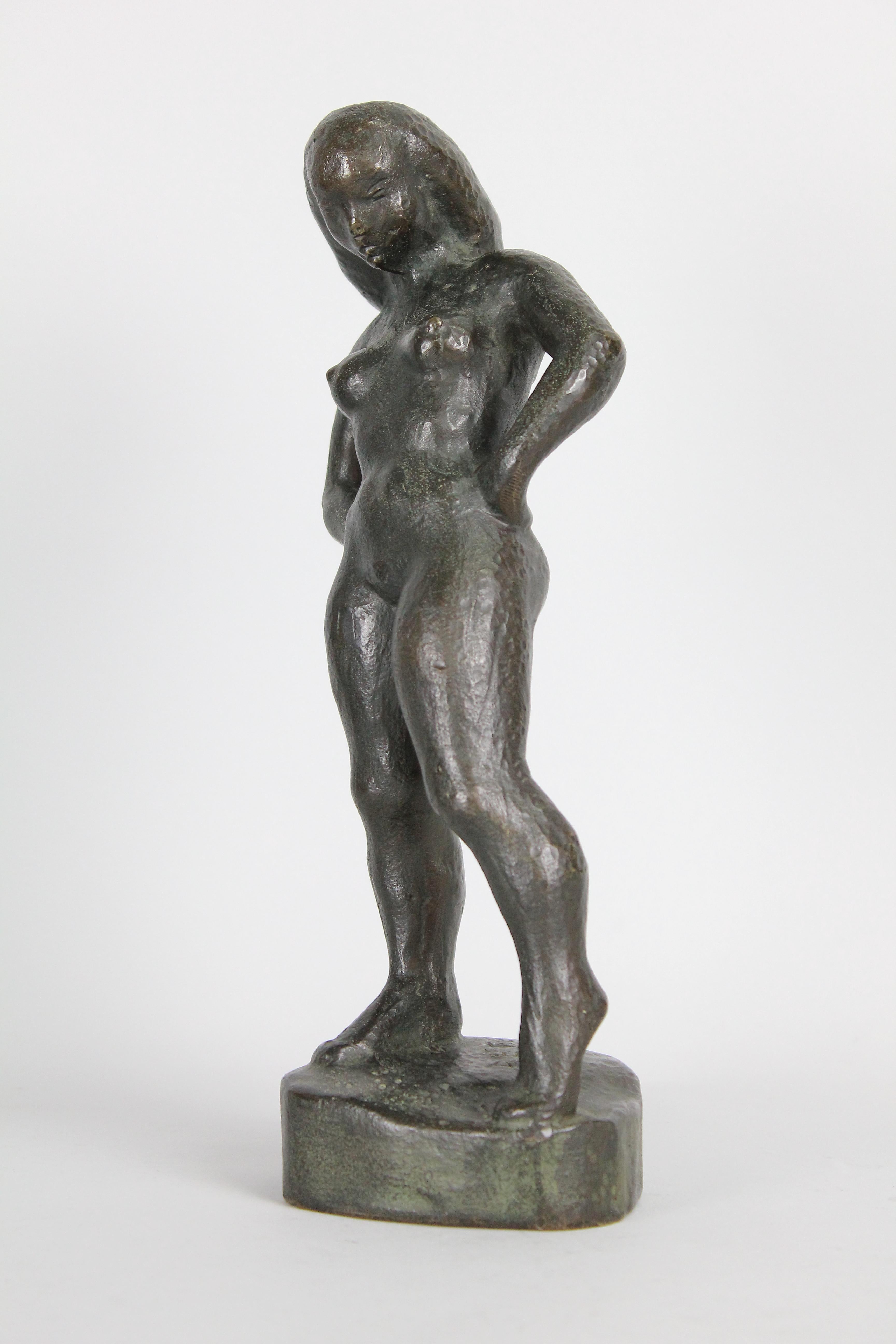 A young woman with an attitude! That pose says it all!

Cast in bronze and patinated in dark green/brown. Signed 