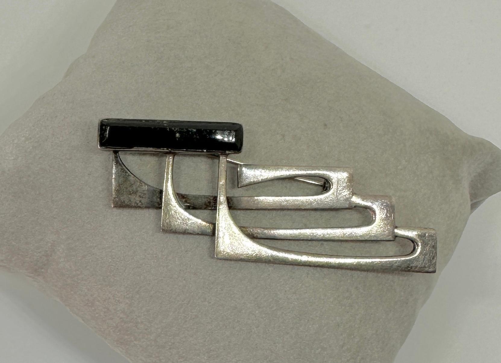 This is a very fine mid-century modern Black Onyx Sterling Silver brooch by Sigi Pineda of Mexico.  Signed Sigi Taxco Sterling and numbered 416 I believe. The Mexican sterling silver modernist brooch is a masterpiece of mid-century design with the