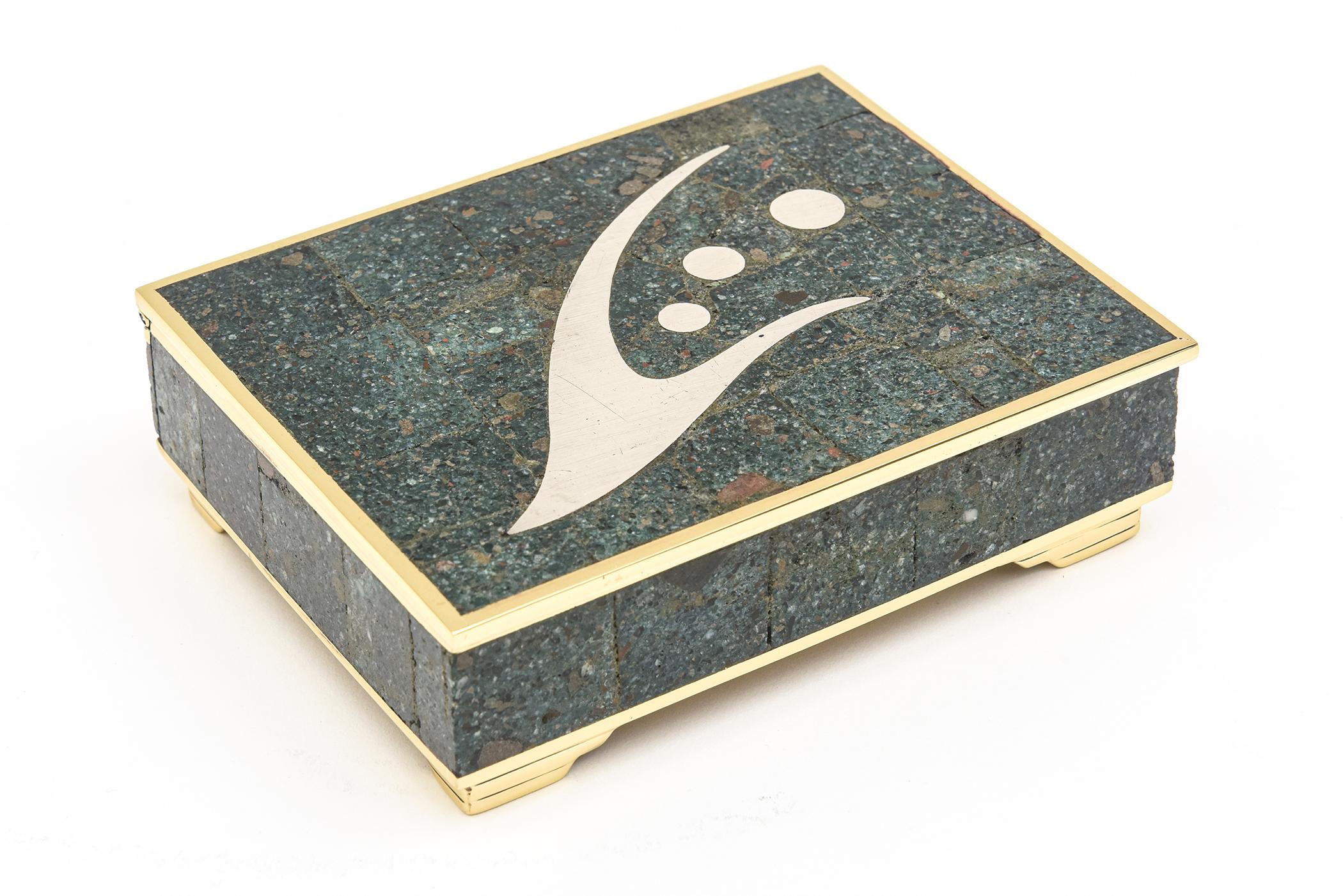 This unique abstract signed Mid-Century Modern mixed media hinged box is by Sigi Pineda and from Taxco Mexico in the 1950s. It is signed Sigi Taxco 8. The box is silver, brass, rosewood interior with the crushed turquoise, sodalite and other crushed