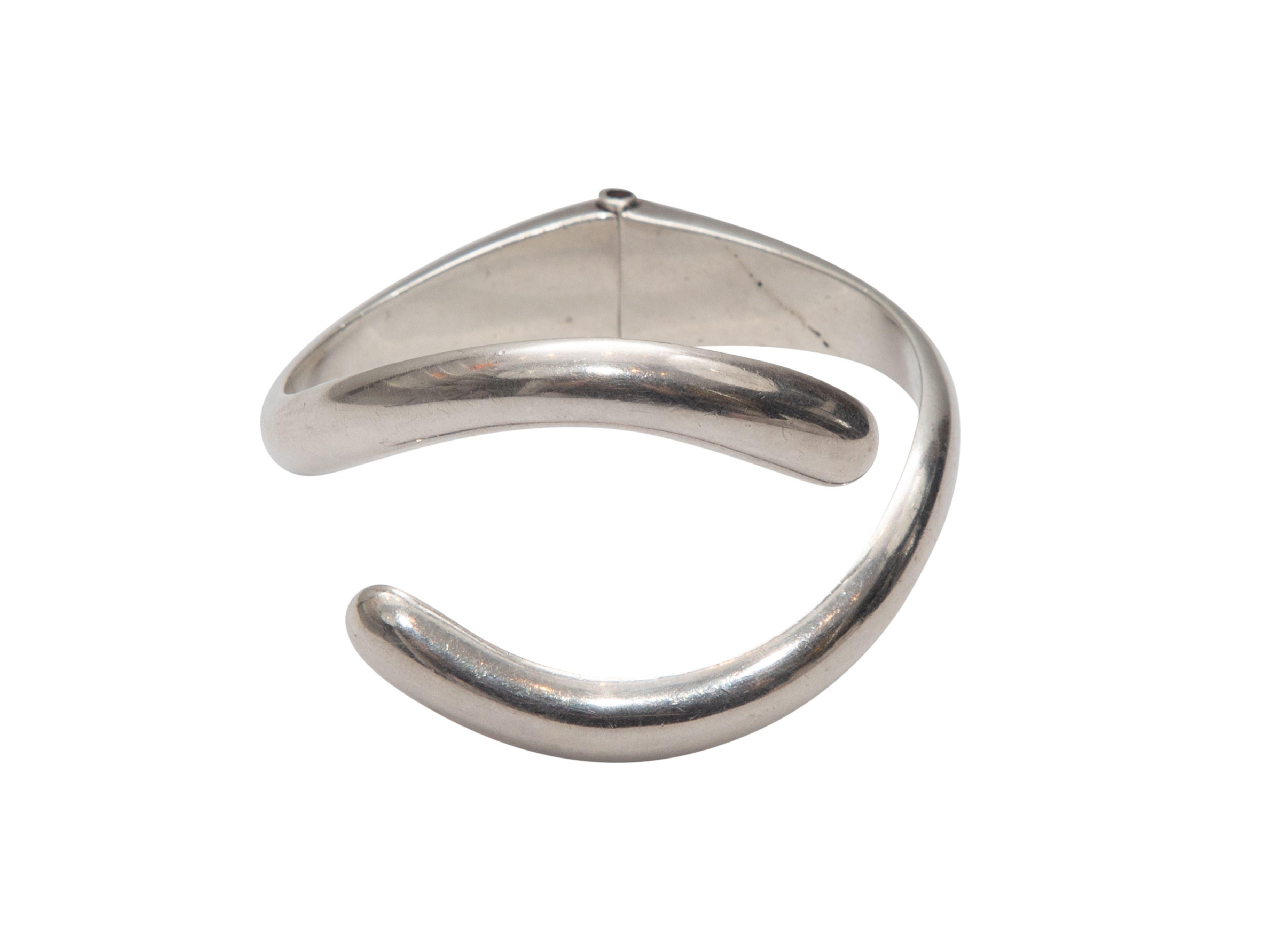Product Details: Sterling silver Bypass hinged cuff bracelet by Sigi Pineda. 1.5