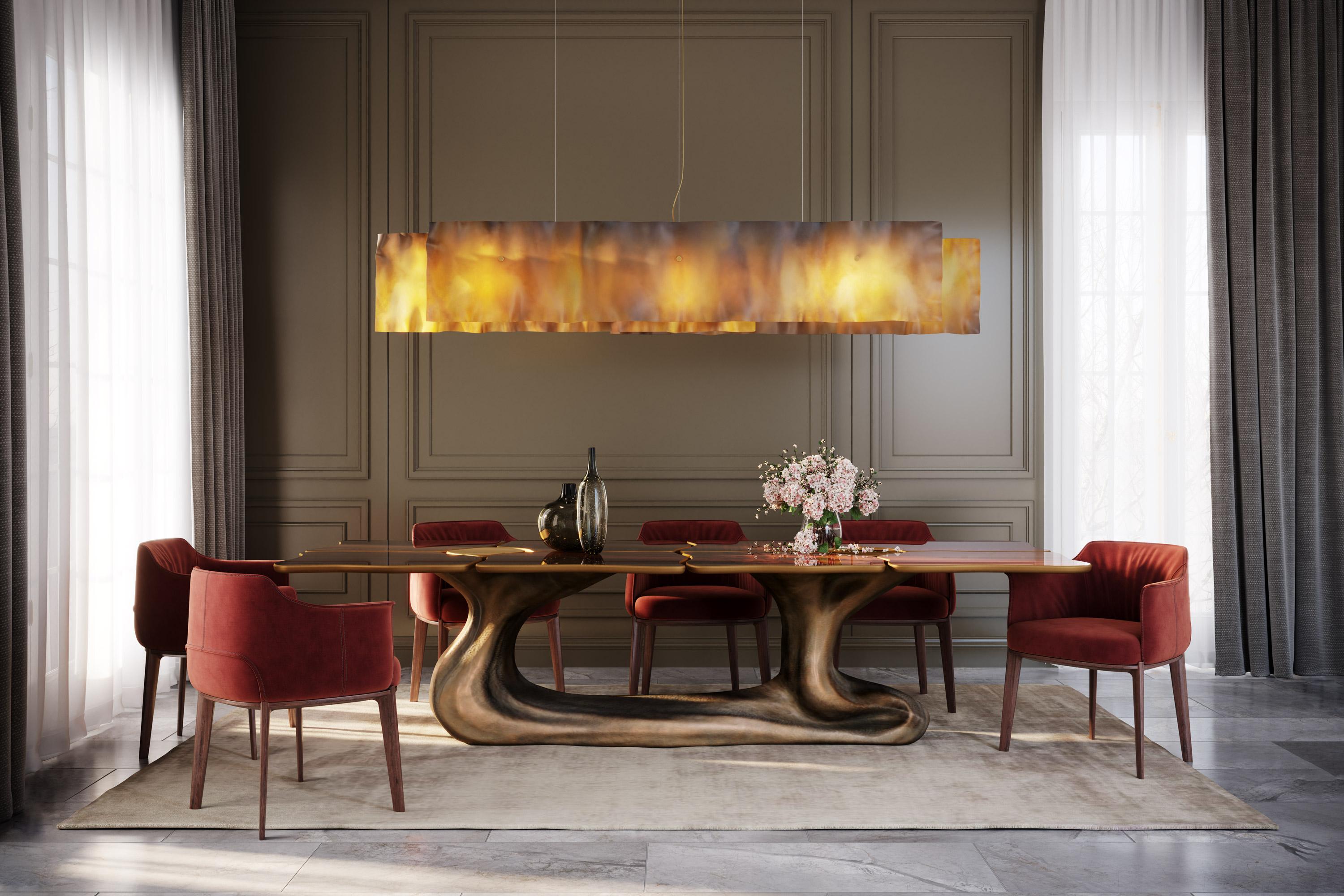 Sigma is a luxurious and sculptural dining table that is handmade produced in resin reinforced with fiberglass and combines bold finishes with amazing materials and textures. Its table top is made of walnut root veneer with high gloss finish and its