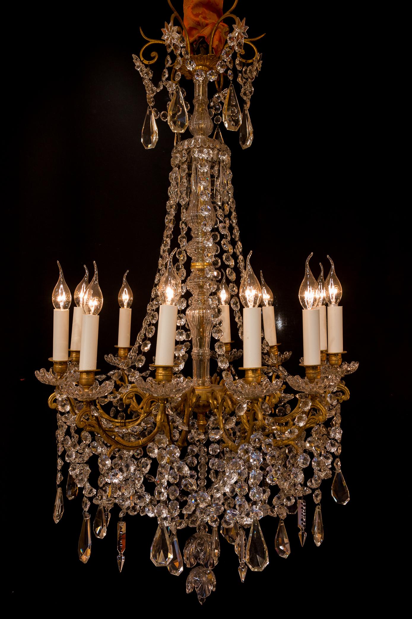 Sign by Baccarat French Louis XVI style bronze and cut crystal chandelier, circa 1870

A lovely and decorative chiseled bronze and cut crystal chandelier in the Classic French Louis XVI style. 
Our chandelier is composed of twelve perimeter