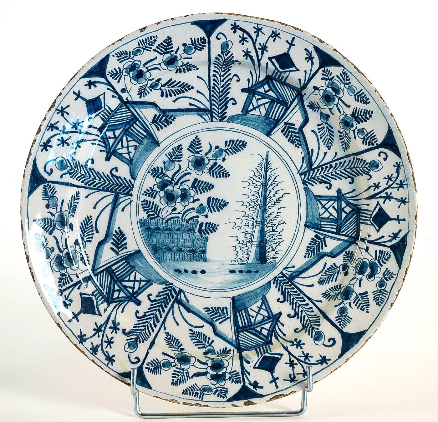 We are pleased to present you, a magnificent and rare Delft faience plate, hand-painted in a blue cameo, depicting churches and in a centre flowers.
Our plate signed on the backside in blue, JJ, for Jan Jansz Van Der Laen who managed the Three