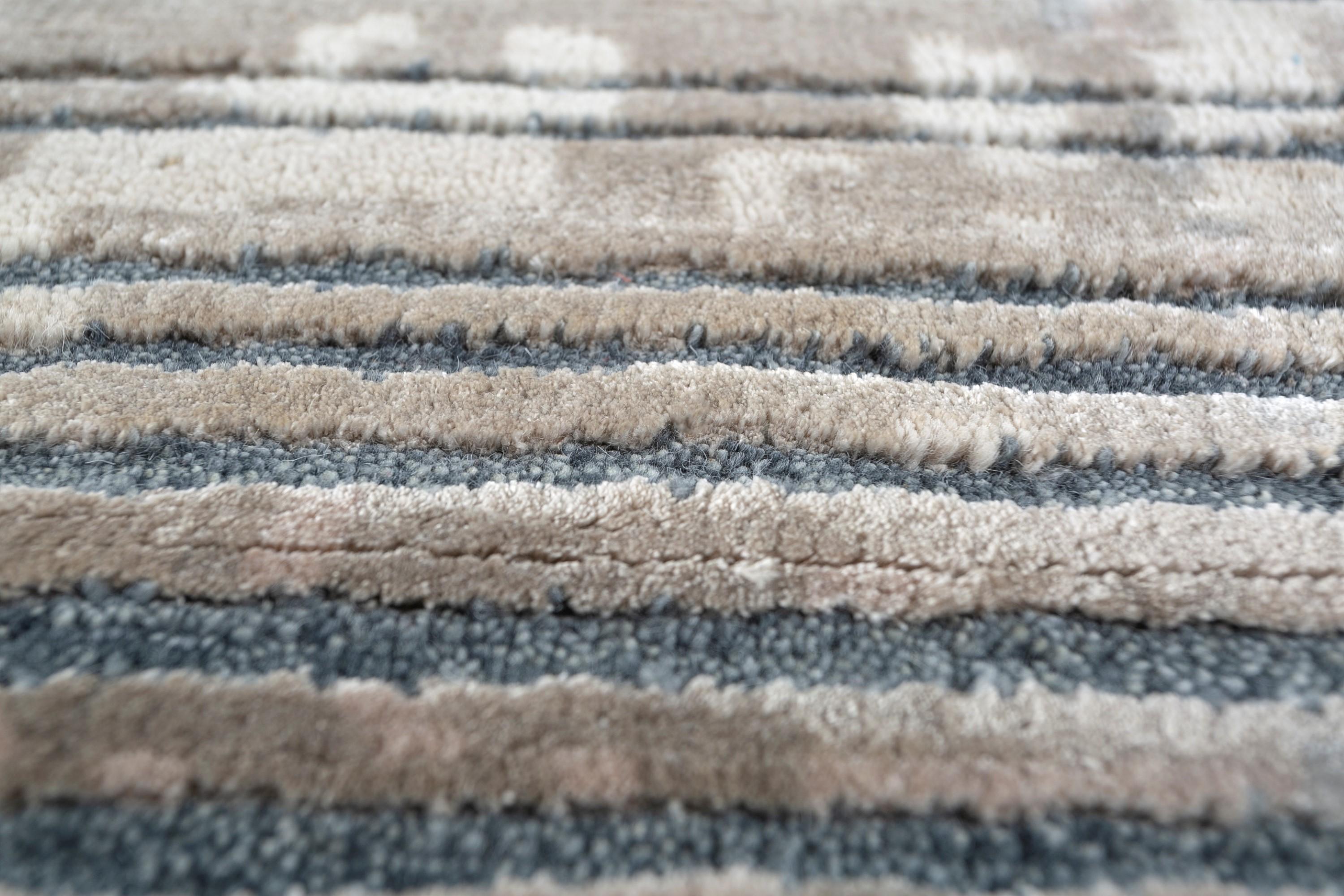 Crafted for contemporary spaces, this handknotted rug by transcends the realm of floor covering, transforming into a visual masterpiece. Its captivating design is more than just aesthetically pleasing, with a mesmerizing interplay of mesh textures