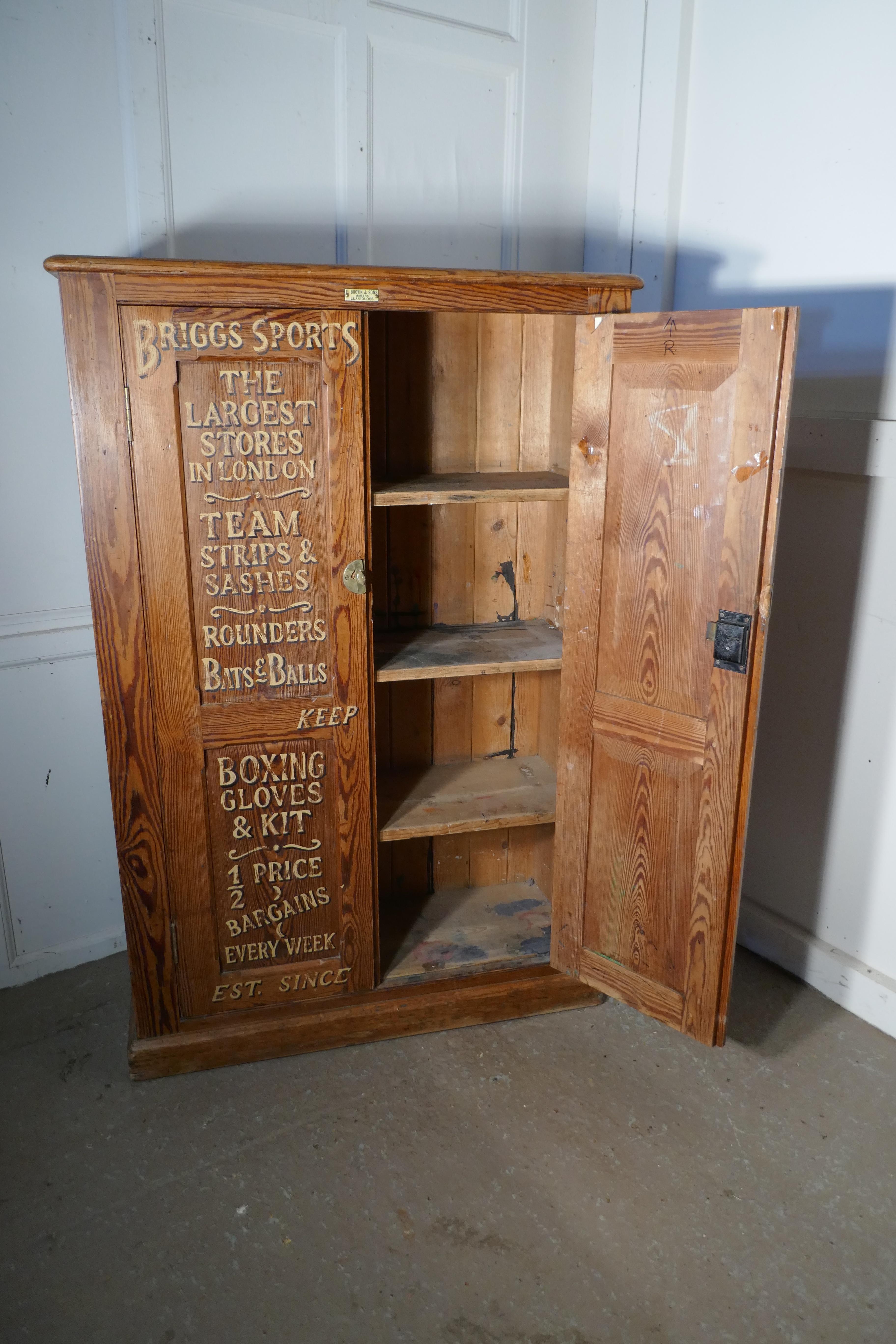 Sign painted pitch pine school cupboard, sports equipment cupboard.

Made by Llanidloes and painted to advertise biggs sports stores the famous London company
the double door cupboard is made in heavy pitch pine, inside it has 3 fixed