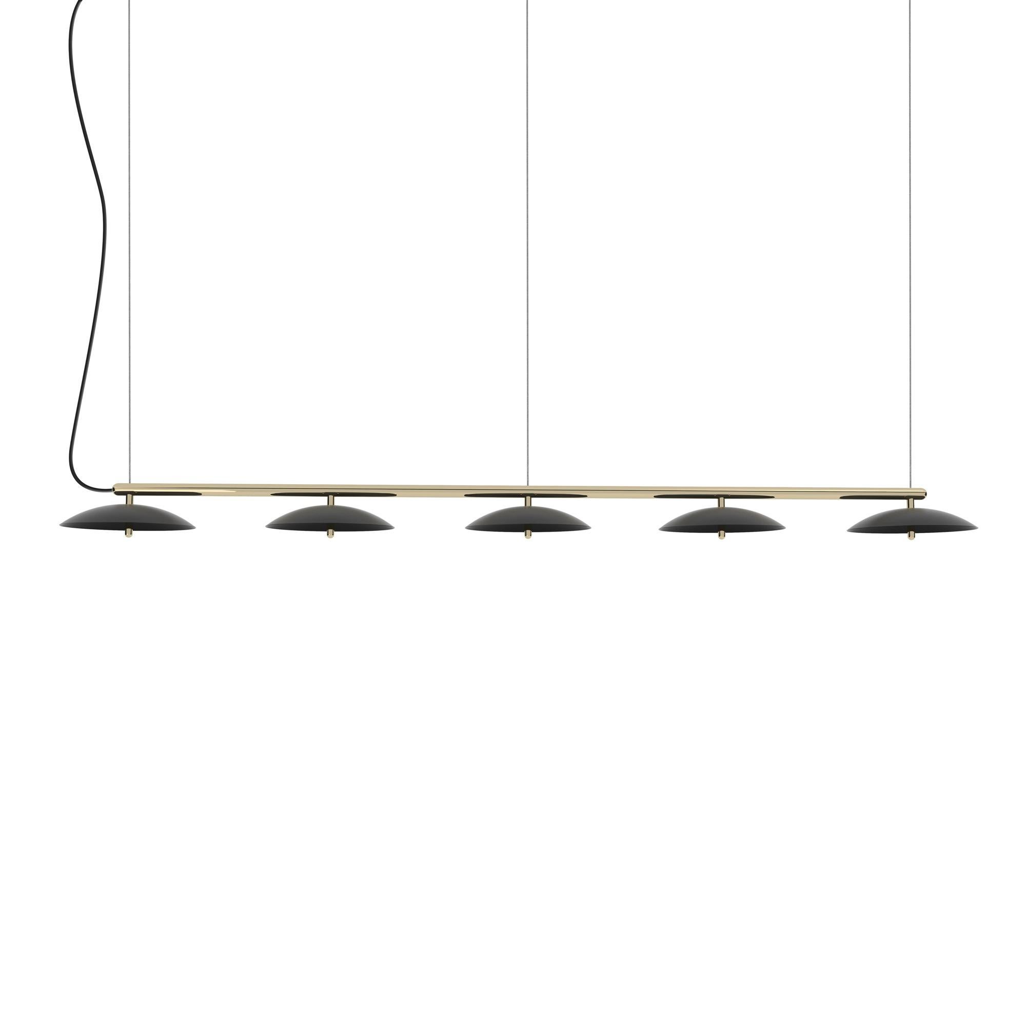 Perfect above a dining table or a conference table, the signal linear pendant is a decidedly modern linear suspension light. A polished metal arm effortlessly supports spun metal shades that cast a downward glow through perforated diffusers.