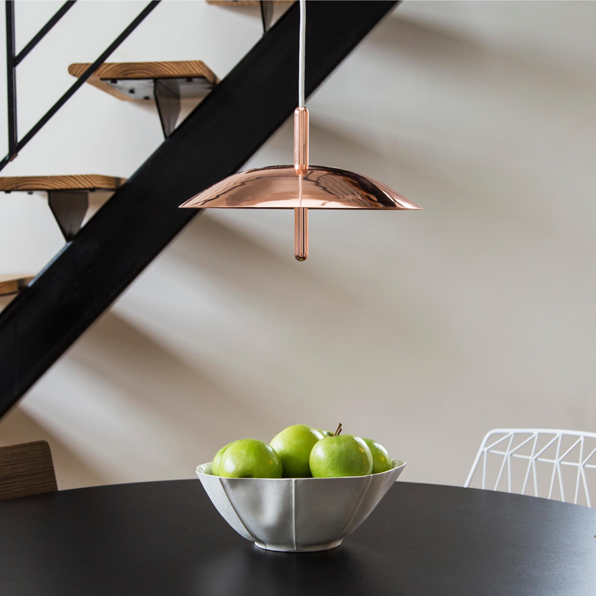 Utilizing warm LEDs and indirect light, signal pendants hover above any interior like a celestial body emitting a comforting glow. Consisting of a spun metal shade pierced by a polished central stem, the signal pendant is minimal and expressive.