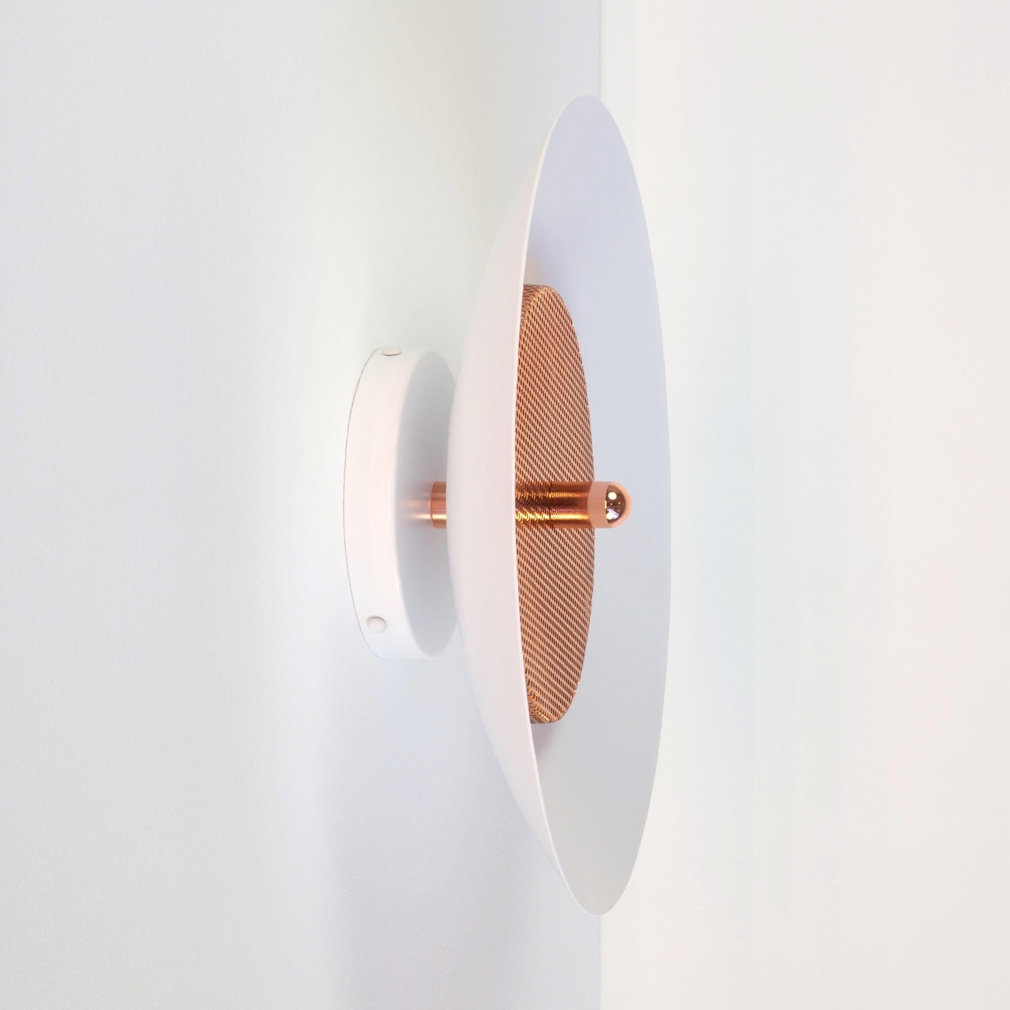 Modern sconce or flush mount. Composed of a spun metal shade that reflects light filtered through a perforated metal diffuser, the subtle warmth of the signal sconce is perfectly balanced by it’s striking form. With their refined lines and numerous