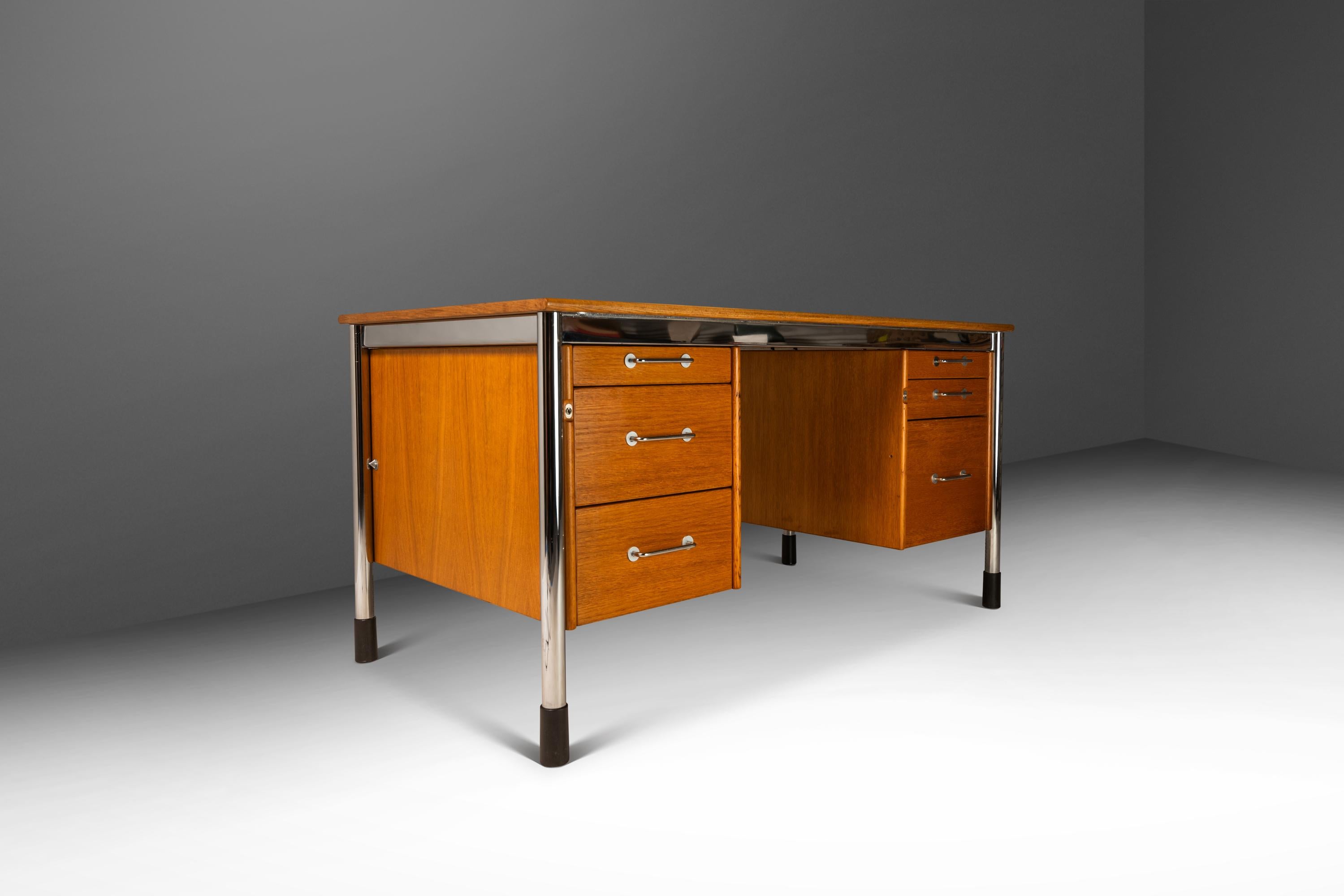 Introducing a rare, vintage 'Signatur' executive desk designed by the influential Tord Bkorklund for IKEA. Constructed from a mix of honey oak and chrome and set on adjustable plastic feet this desk was designed with functionality in mind. In
