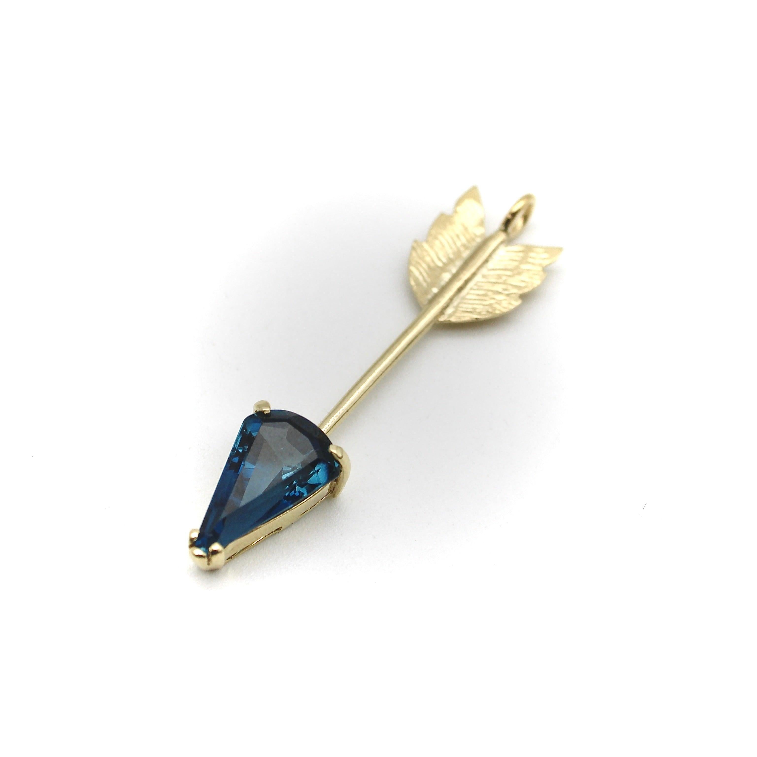This gorgeous 14K gold arrow features a luminous London Blue Topaz. This signature piece was inspired by the arrows of martyrdom of Saint Sebastian. An iconic figure, he was ordered to be killed by the Roman emperor Diocletian. He was persecuted and