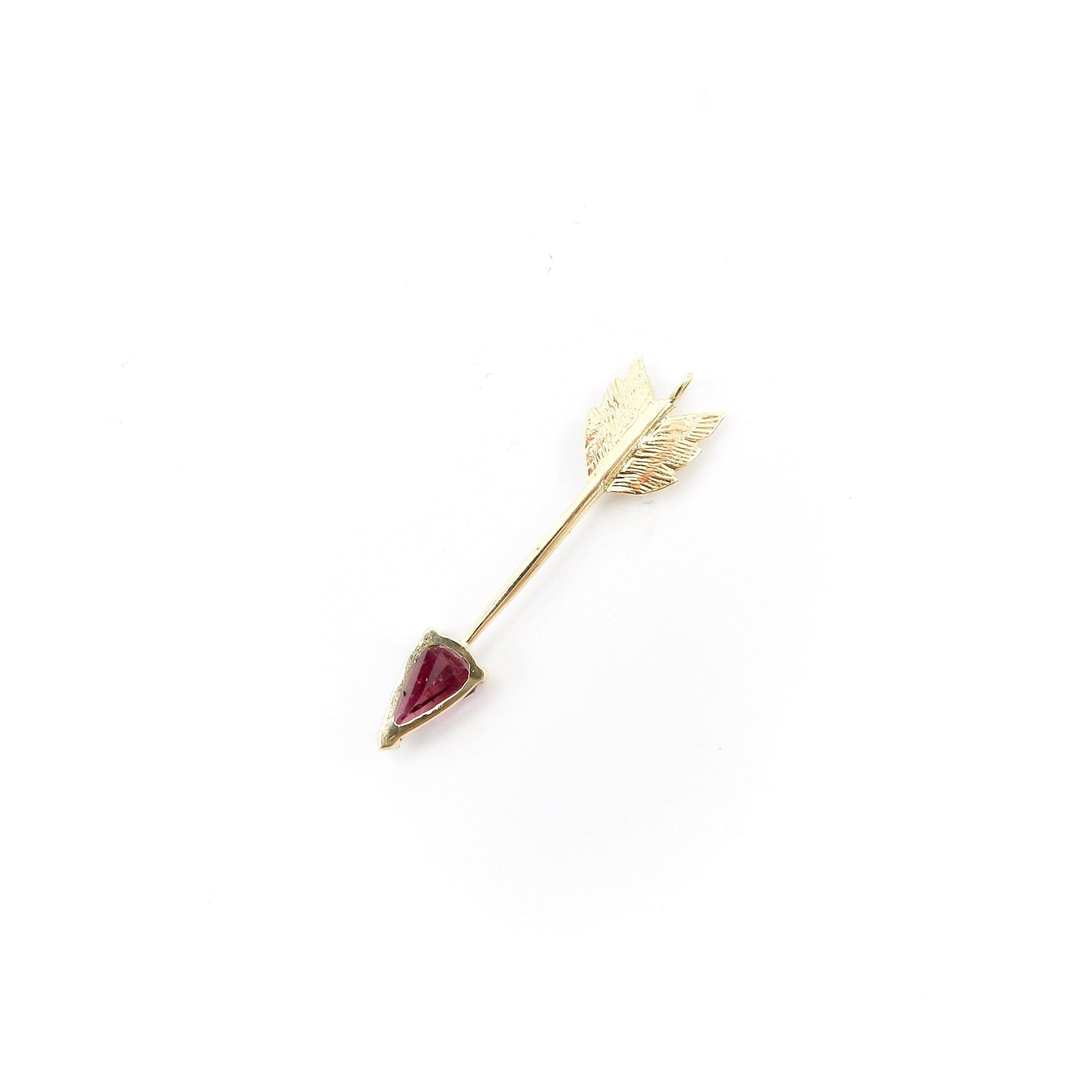 This gorgeous 14K gold arrow features a luminous pink tourmaline. This signature piece was inspired by the arrows of martyrdom of Saint Sebastian. An iconic figure, he was ordered to be killed by the Roman emperor Diocletian. He was persecuted, and