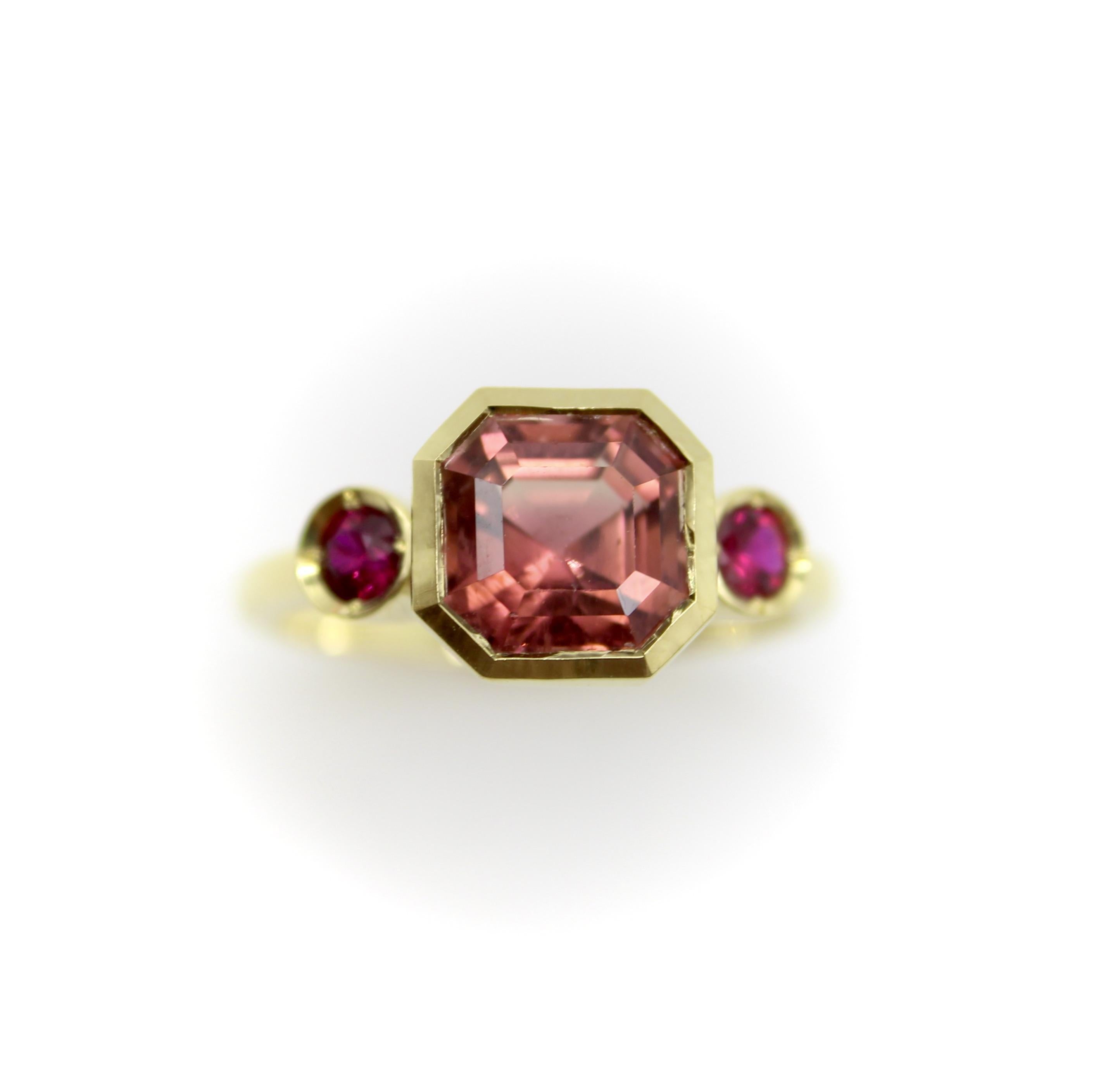 Part of the Kirsten’s Corner Signature collection, this 18k gold three stone ring features a peach tourmaline as its focal point. Sourced from Tanzania, the tourmaline is a deep stone with facets that draw you into its center. Its many facets pull