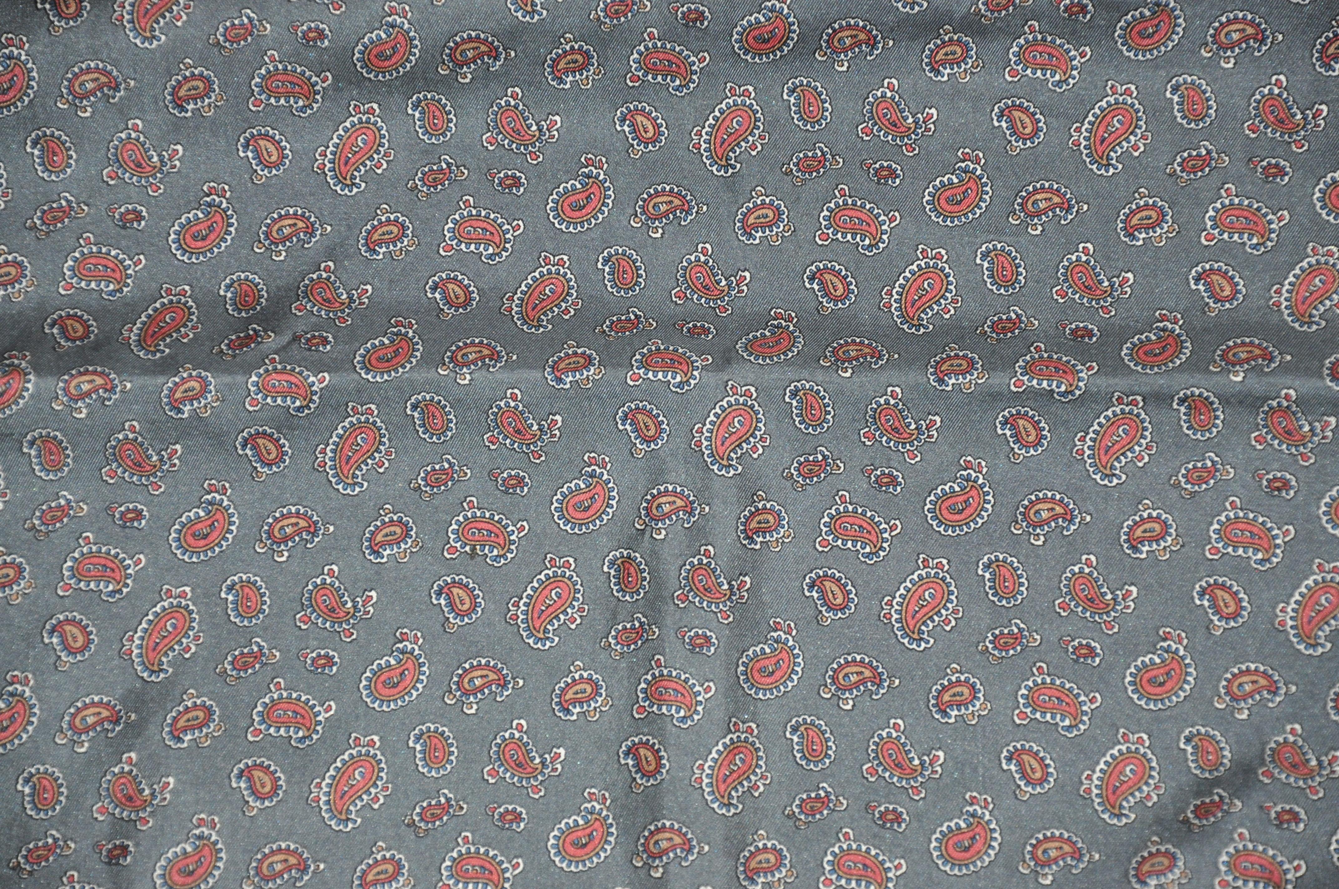     This wonderfully elegant and classic shades of gray paisley silk handkerchief with hand-rolled edges, measures 16 and a half inches by 17 inches. Made in Italy.