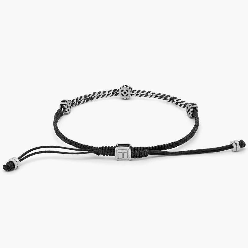 Signature Gear Bracelet in Black Macramé with Sterling Silver, Size L

Three gears move smoothly around a section of highly-polished curb chain, finished in rhodium plated sterling silver. Our intricately hand-wrapped black macramé takes up to two