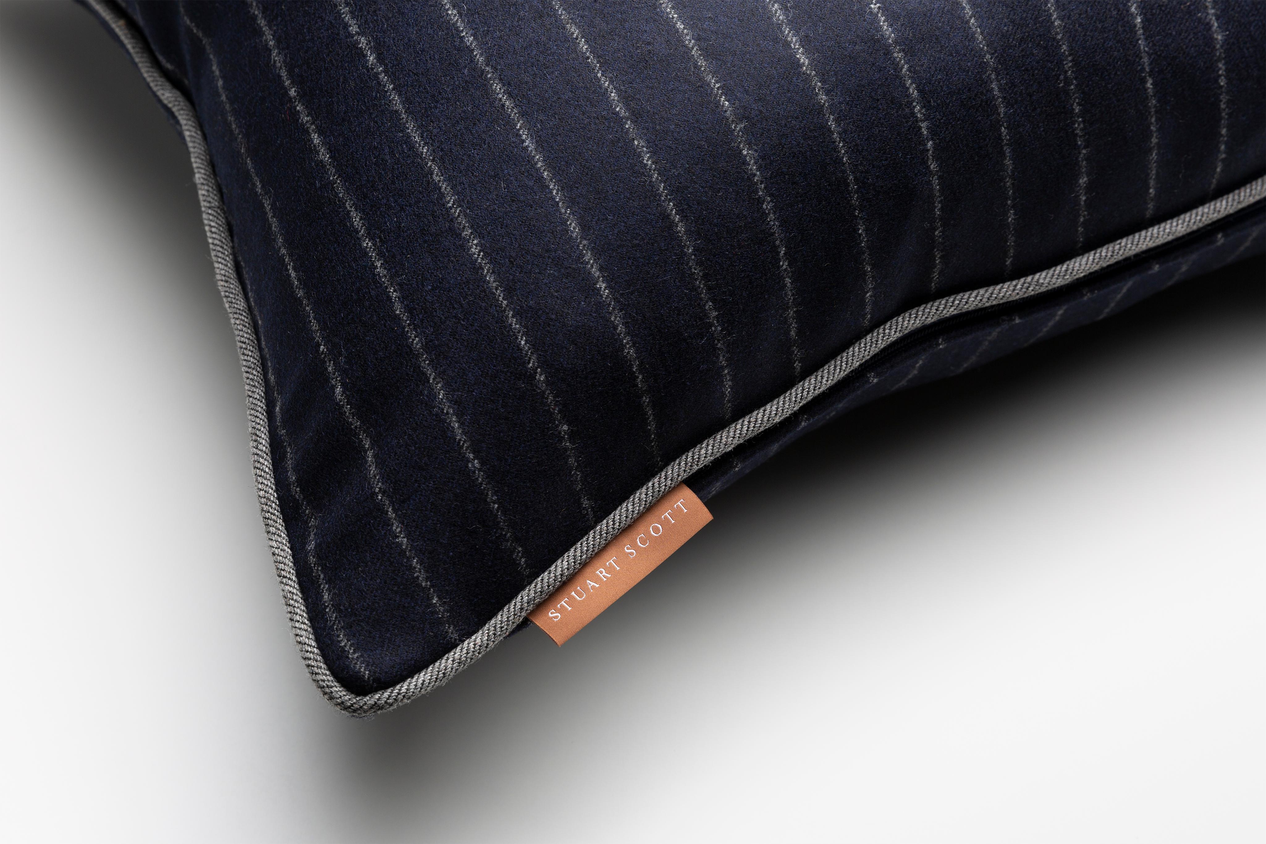 The Signature cushion is soft and sumptuous with an elegant pattern of delicate pinstripes, an ideally classic and handsome accessory for your lounging space.

Savile Row Navy chalk stripe wool with tailored grey piping and a luxurious feather and