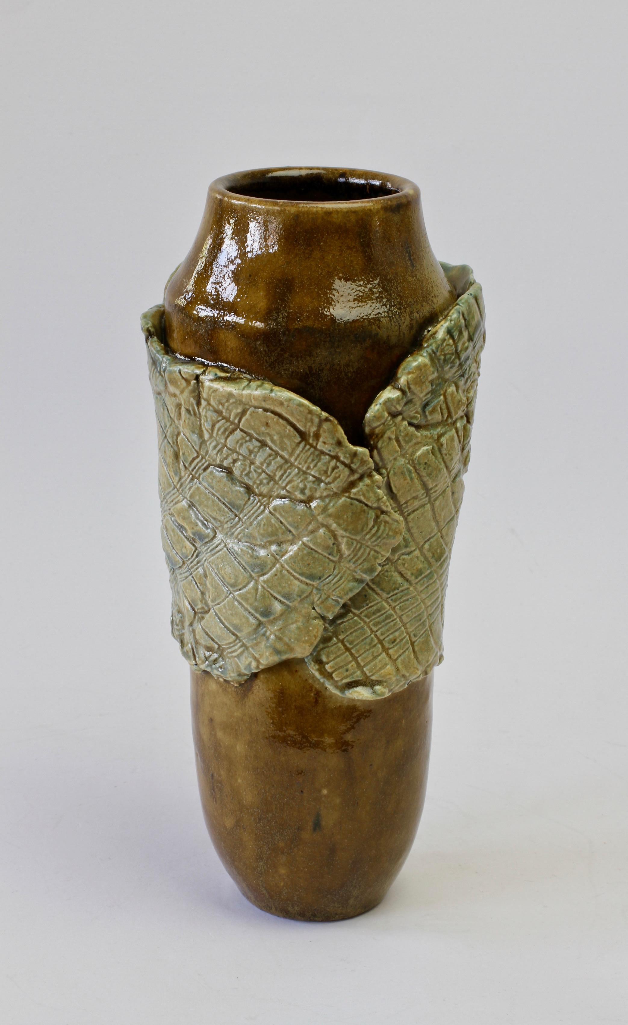 Signed European studio art pottery vase by Signe Pistorious-Lehmann (1925-2012). Beautiful organic form referencing the natural forms of plants with the wood like brown glaze of the vase which is enveloped in what feels very much like a large green