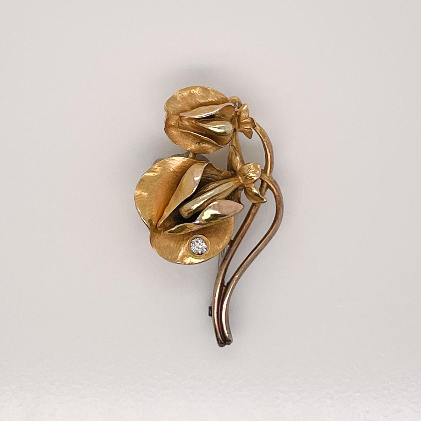 A very fine signed gold and diamond brooch.

With two finely modeled Butterfly Pea flowers (Centrosema Virginianum) in 14k yellow gold. The butterfly pea flower is known for its unique petals and wonderful viney growth. 

The larger of the two