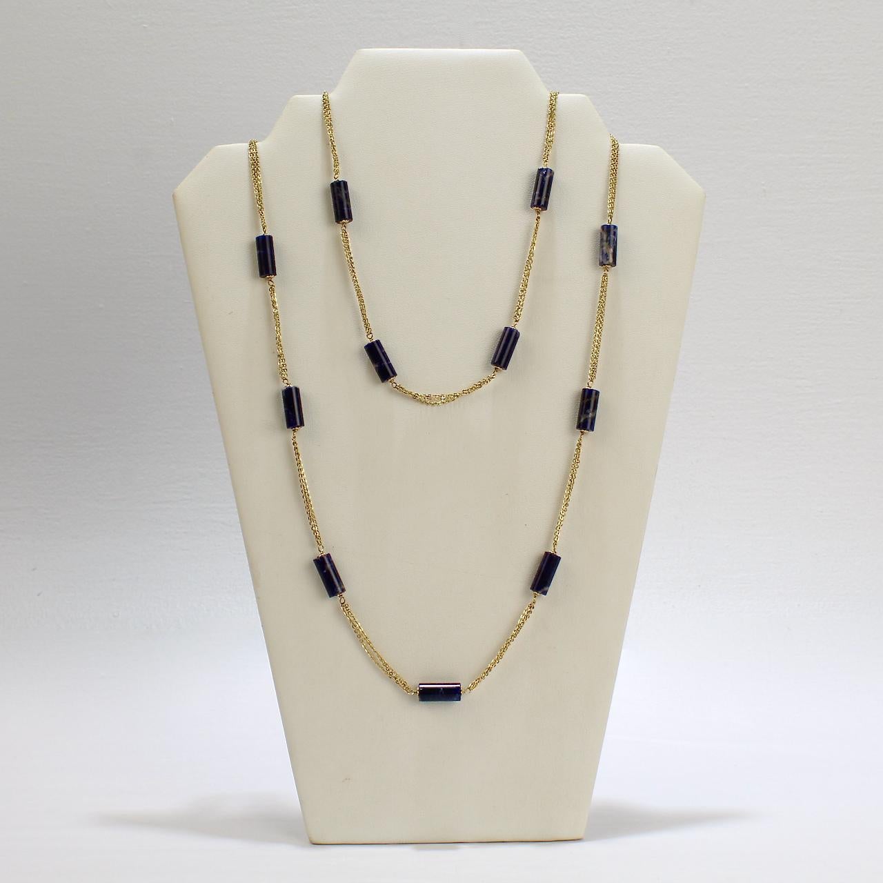A fine Italian 18 karat gold and Lapis Lazuli beaded rope length necklace.

Made by Filippini Fratteli.

With cylinder shaped lapis beads capped with small gold florets that are interspersed between sections of flat oval cable chain