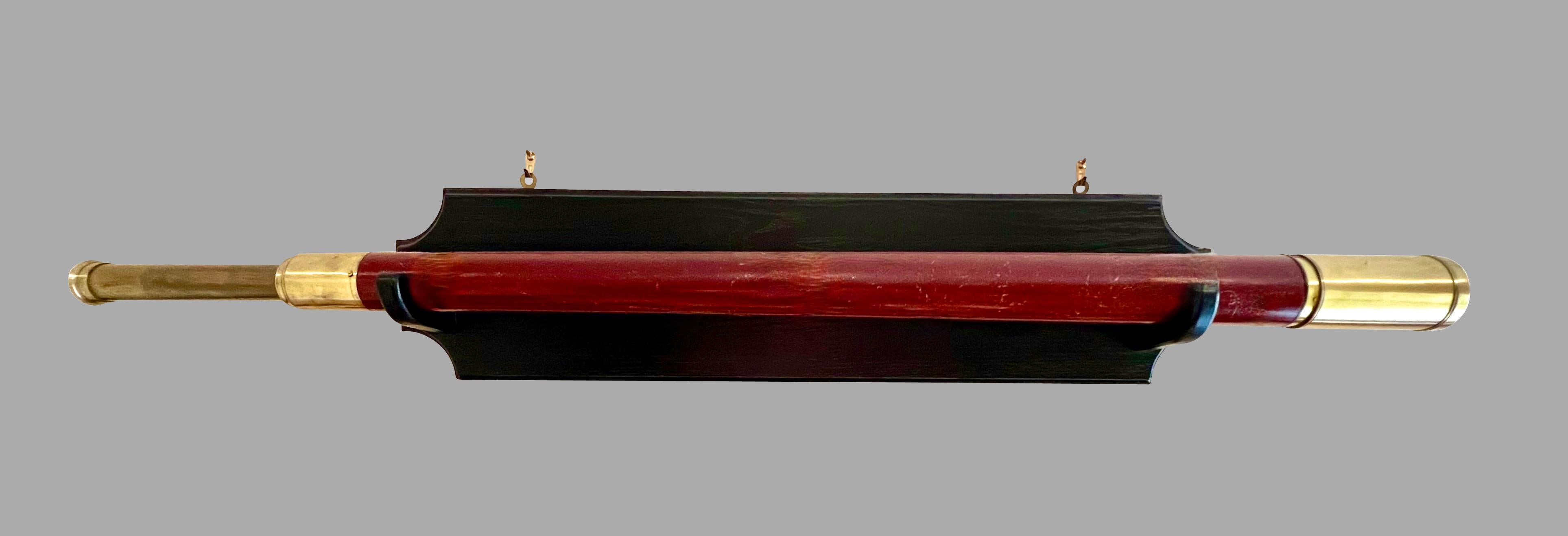 An English mahogany and brass single draw telescope made and signed by William Bruce, Kings Head Court Shoe Lane London, circa 1830. This handsome instrument is in good working order, now displayed on a custom  black painted oak wall mount. The