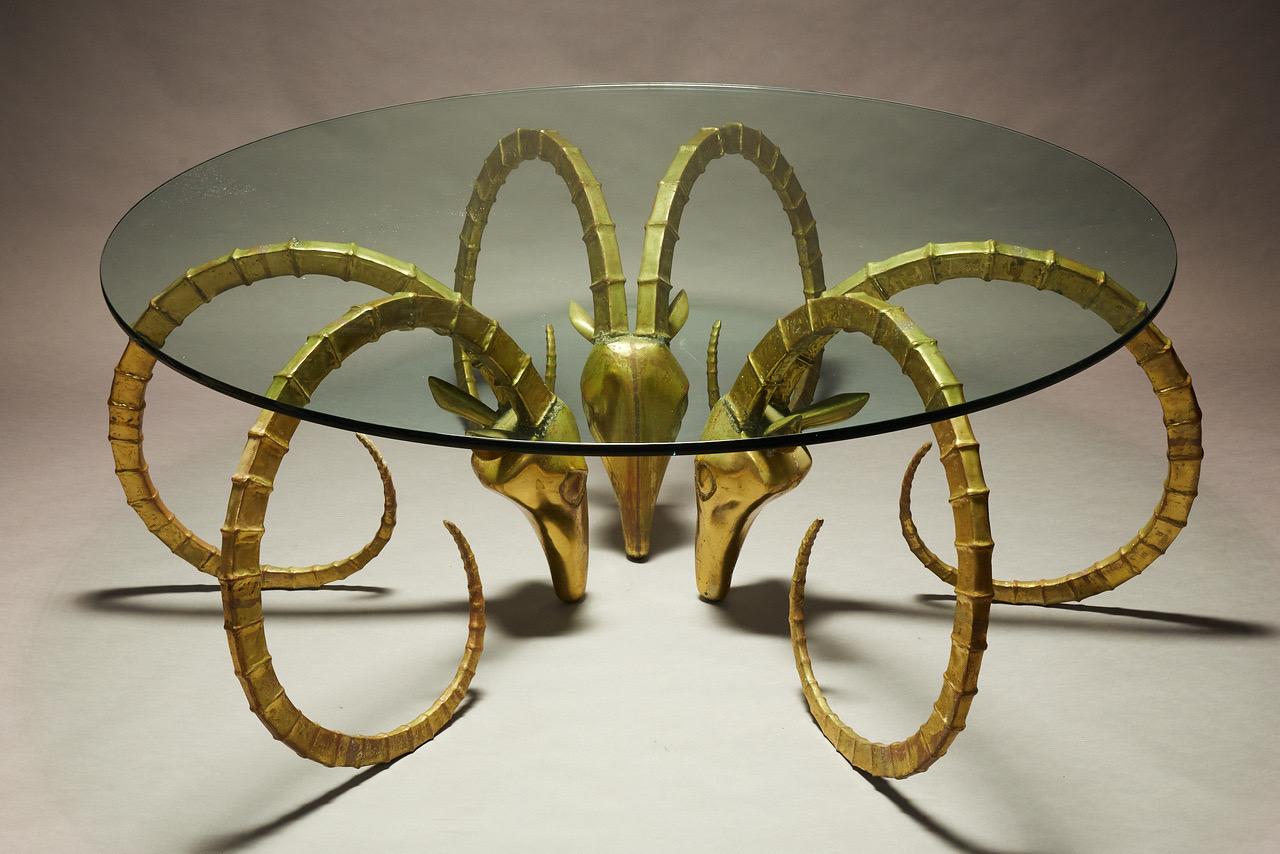 Alain Chervet brass ibex dining table. This table was only made in 150 examples usually consisting of two ibex heads with rectangular glass top. This is probably the only version consisting of three ibex heads for round glass top. All three heads