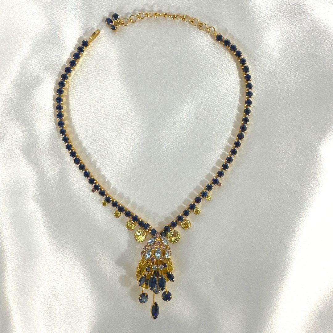 Introducing the epitome of vintage elegance: the Fashion Jewelry Stylish Necklace in a mesmerizing Multi Drop Style by Alva. This exquisite necklace is a symphony of colors, featuring cobalt blue, crystal yellow, light purple, and light blue