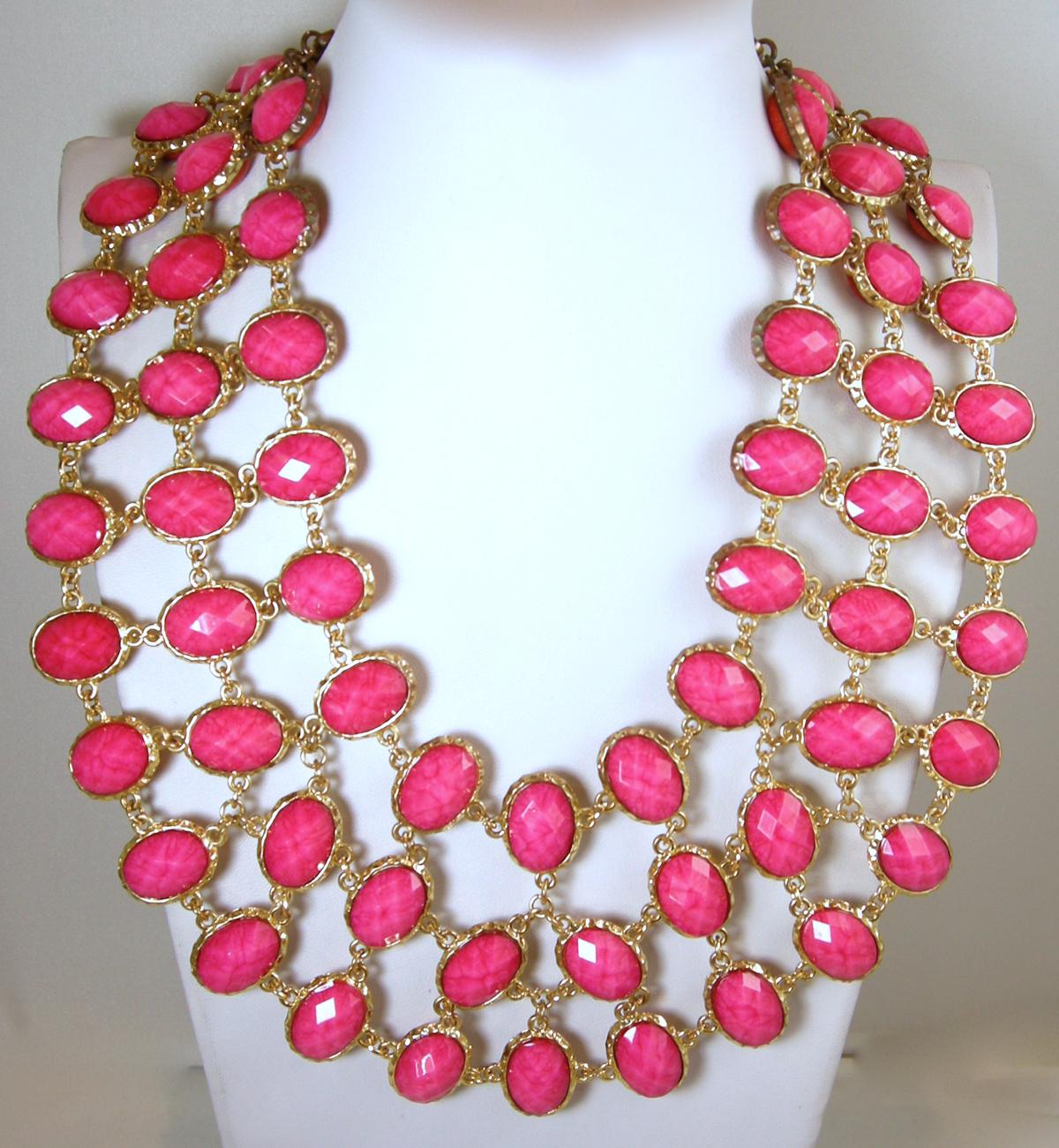 This signed Amarita Singh necklace is reversible and has marbled coral stones on one side and pink faceted stones on the other … in a gold tone setting.  In excellent condition, this necklace measures 20” long with a toggle clasp  and falls 3”.  It