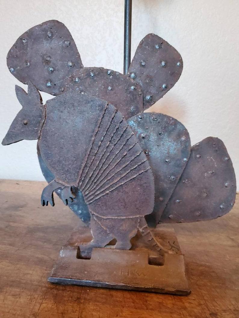 A vintage American folk art, Western Ranch style, hand forged and welded wrought iron fireplace tool holder. Handcrafted in Texas, the artisan who made it cutout signed it by cutting out his initials 