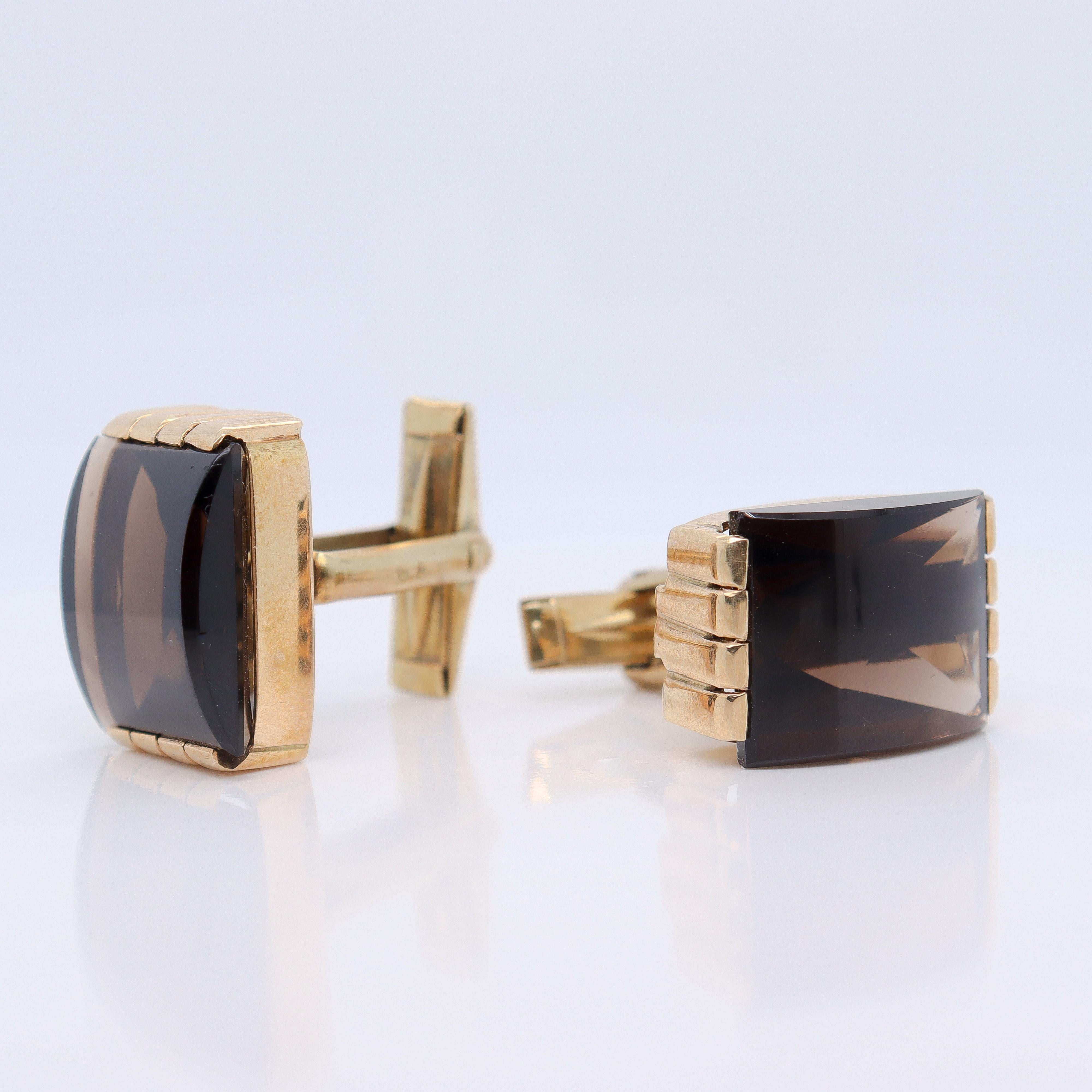 A fine pair of antique Austrian Art Deco cufflinks.

In 14k yellow gold. 

Set with buff top smoky quartz cabochons in a robust geometric Art Deco setting.

Marked with Austro-Hungarian hallmarks for Vienna, 585 & KR for the maker. (The maker