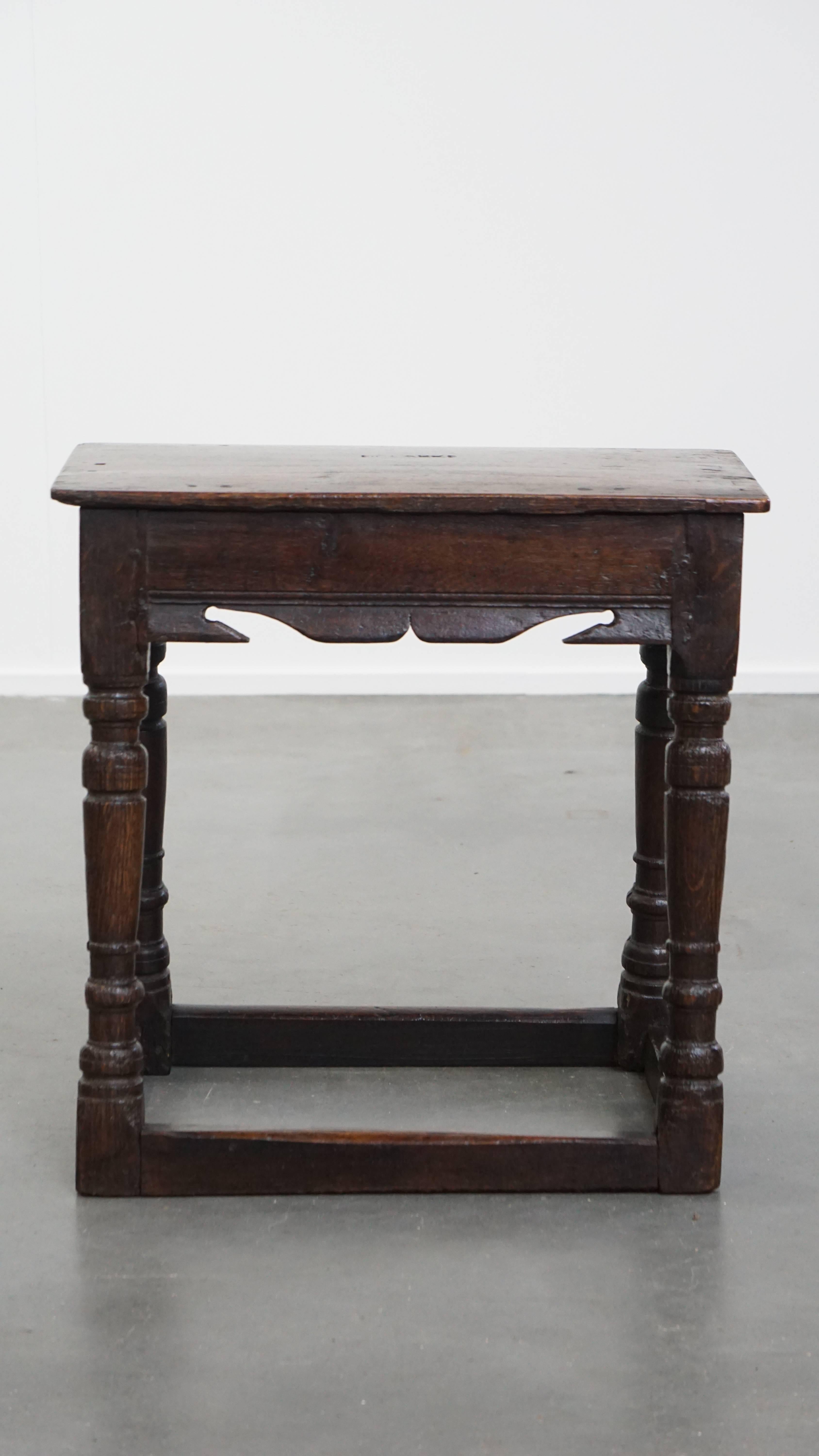 Offered here this charming and versatile signed antique English oak joint stool / stool / side table from the 17th century.

This delightful antique English joint stool / stool / side table from the 17th century combines both charm and
