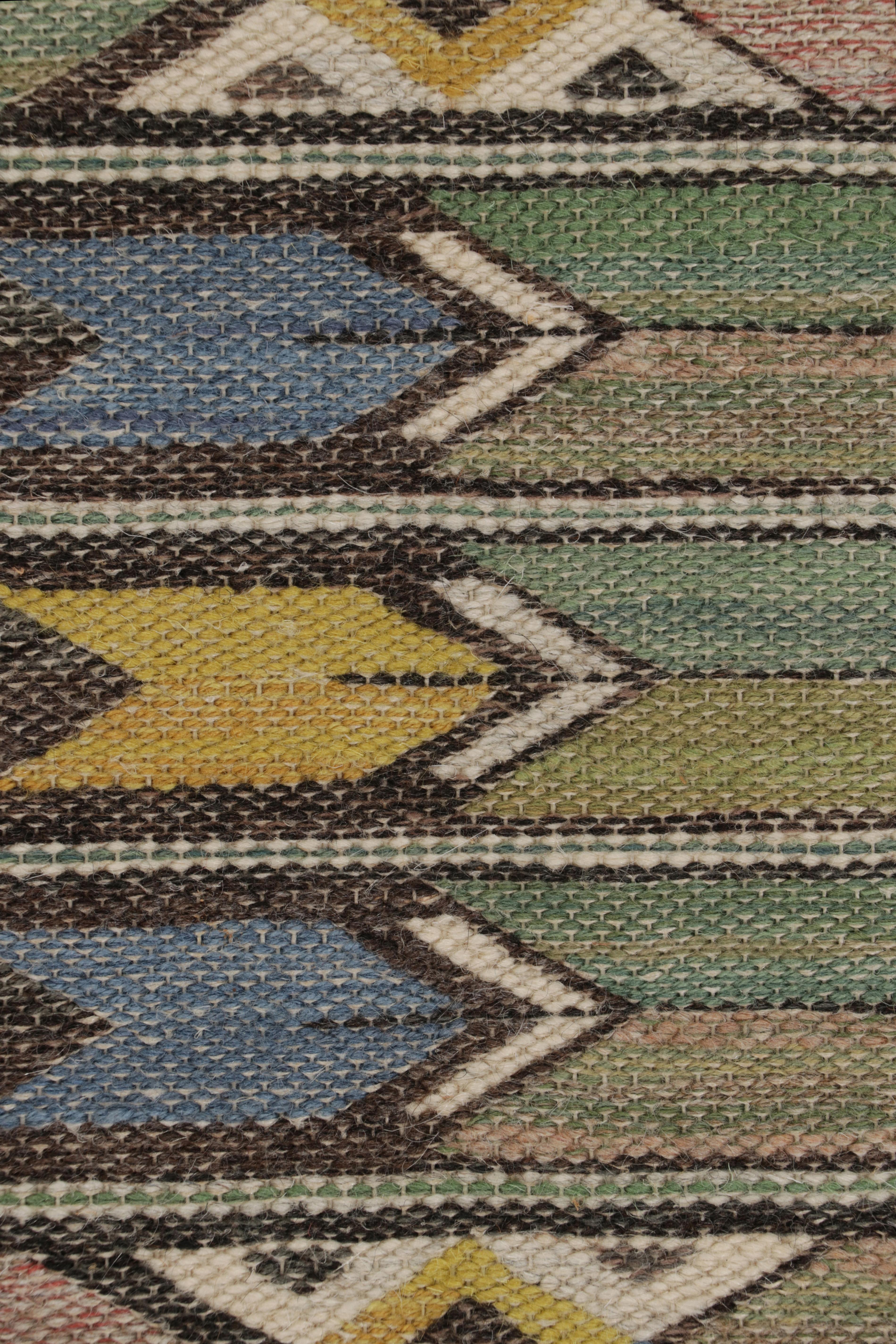 Handwoven in wool in Sweden circa 1920-1930, this 2x10 antique Swedish Rya runner rug is a bold new addition to Rug & Kilim’s curation of iconic Scandinavian rugs of this provenance, signed by the legendary Swedish textile artist, Märta